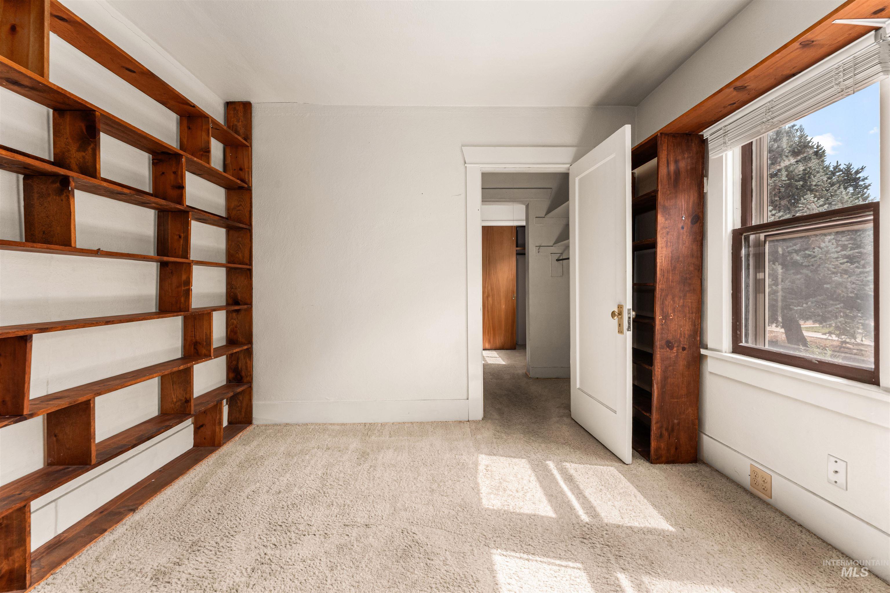 Unfurnished bedroom featuring light carpet