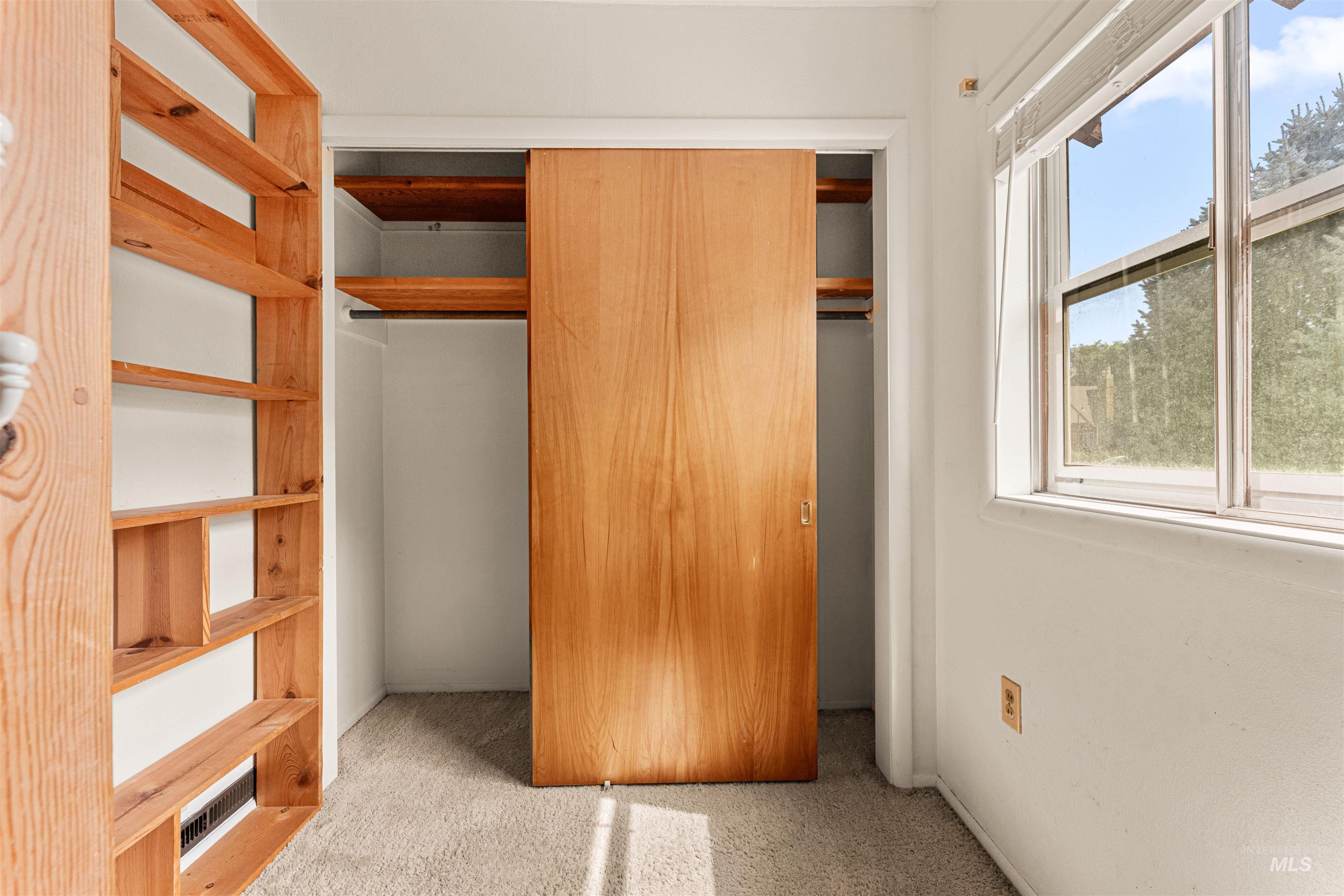 Unfurnished bedroom featuring light colored carpet and a closet