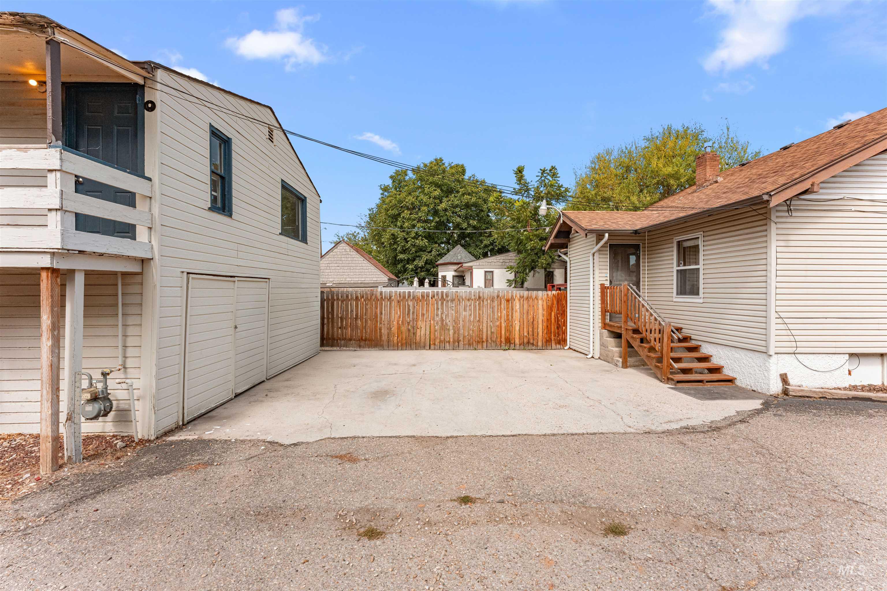 View of side of property featuring a patio and a garage