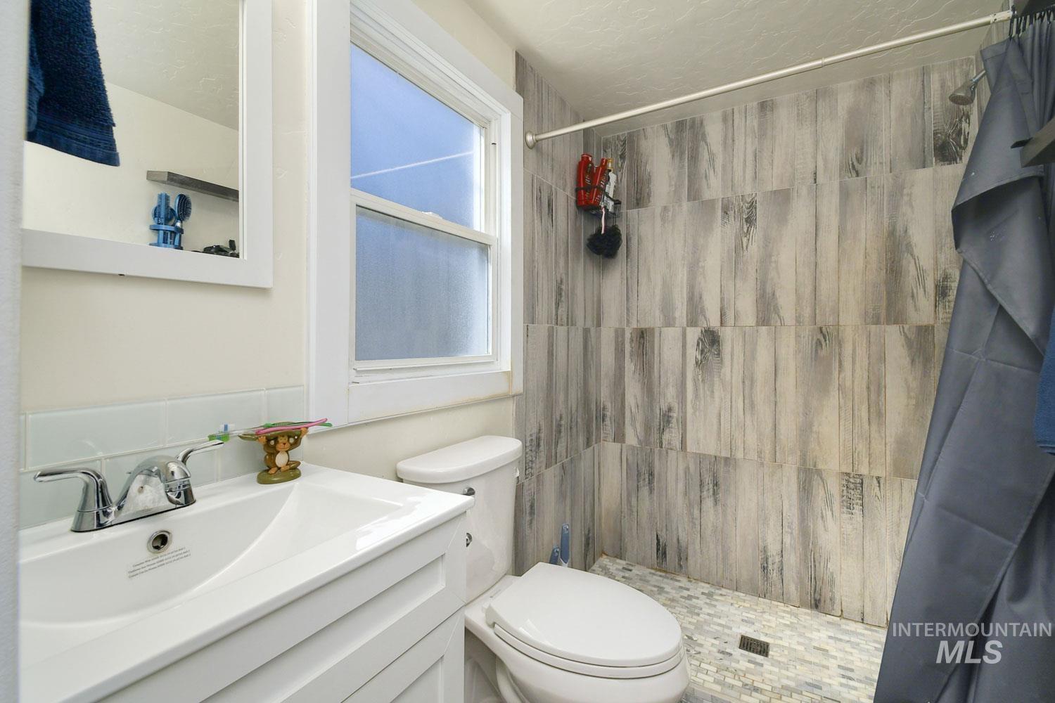 Bathroom featuring a stall shower and vanity