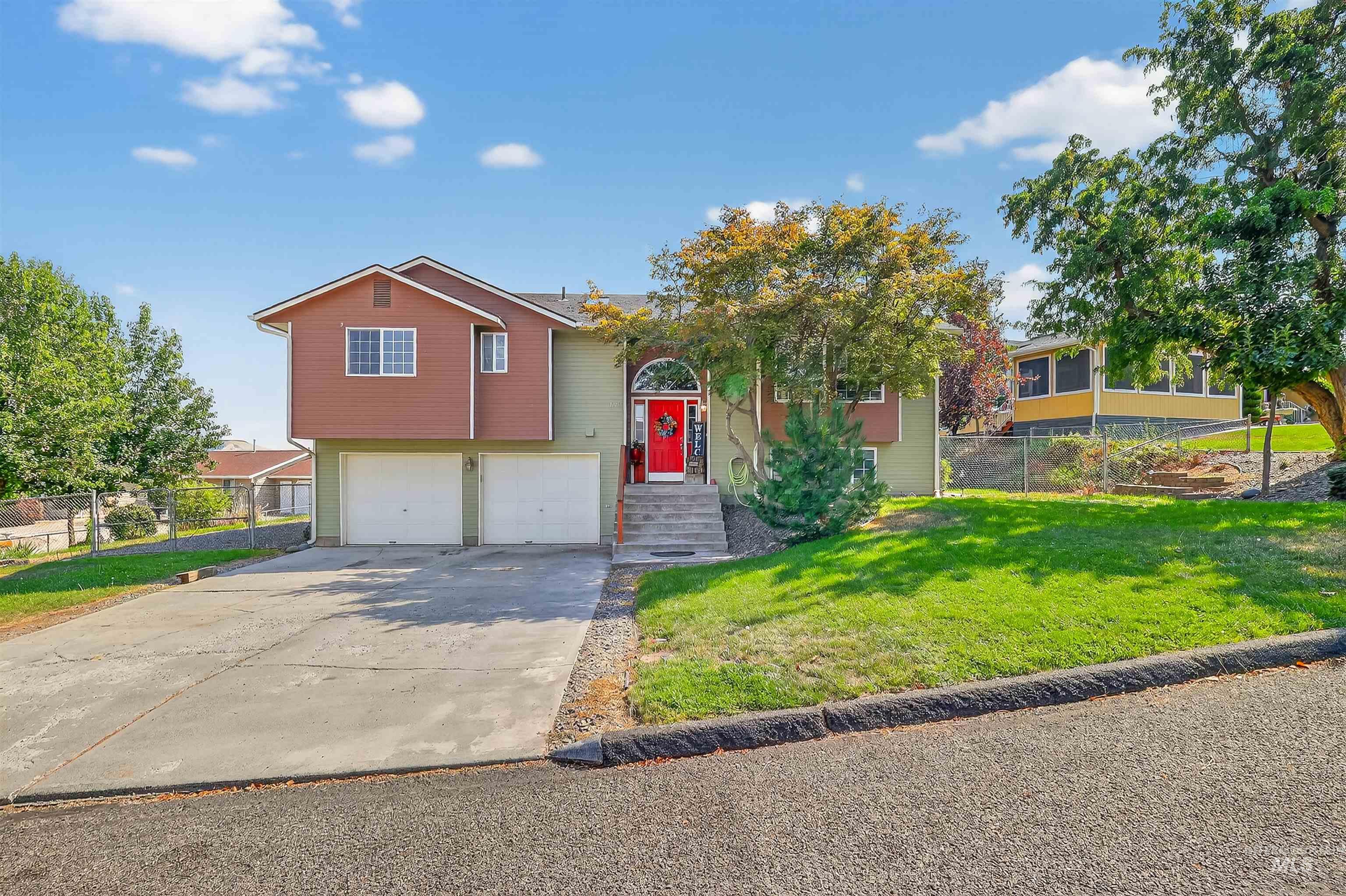 Bi-level home with driveway and a garage