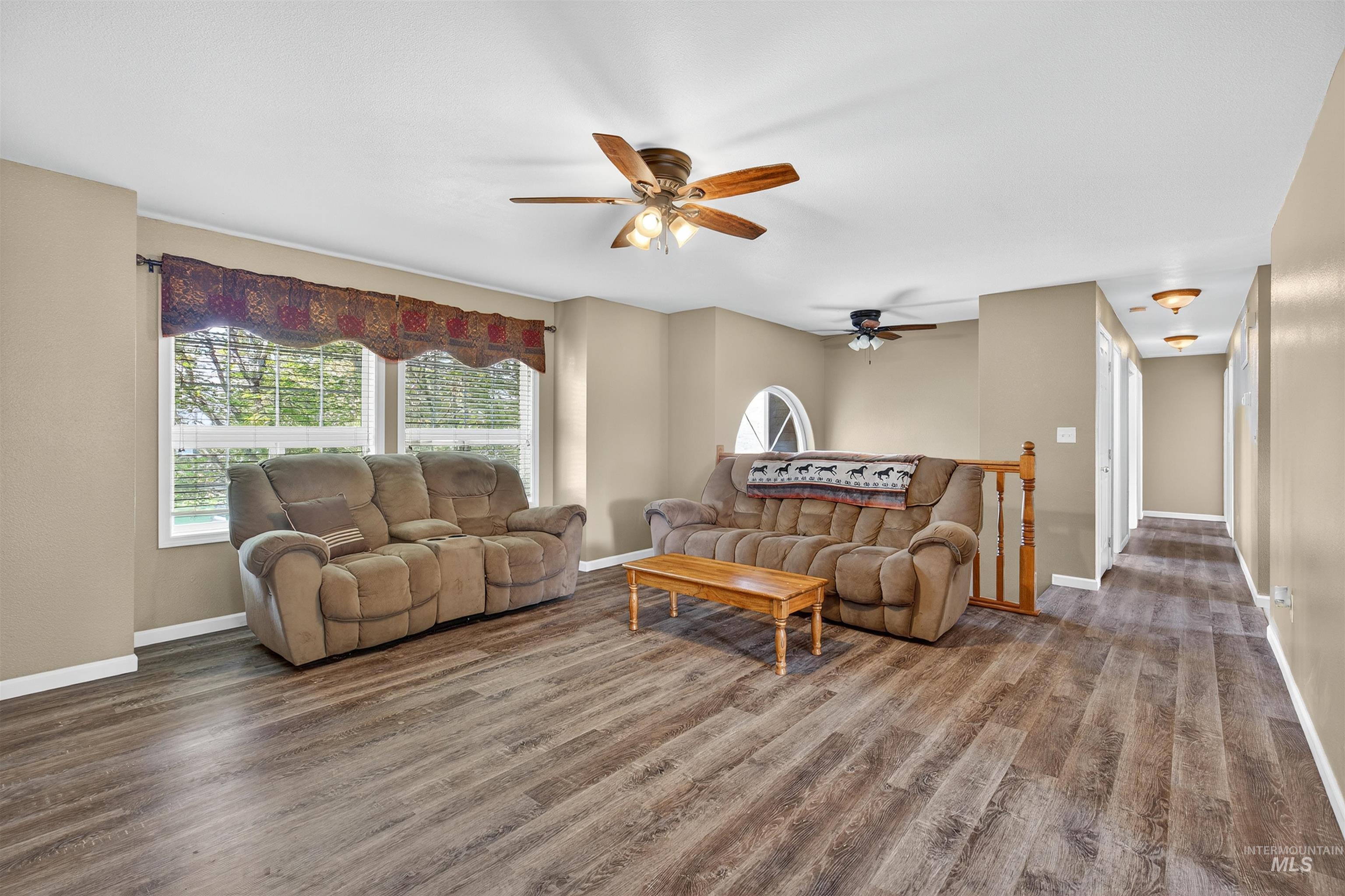 Living room featuring wood finished floors and ceiling fan