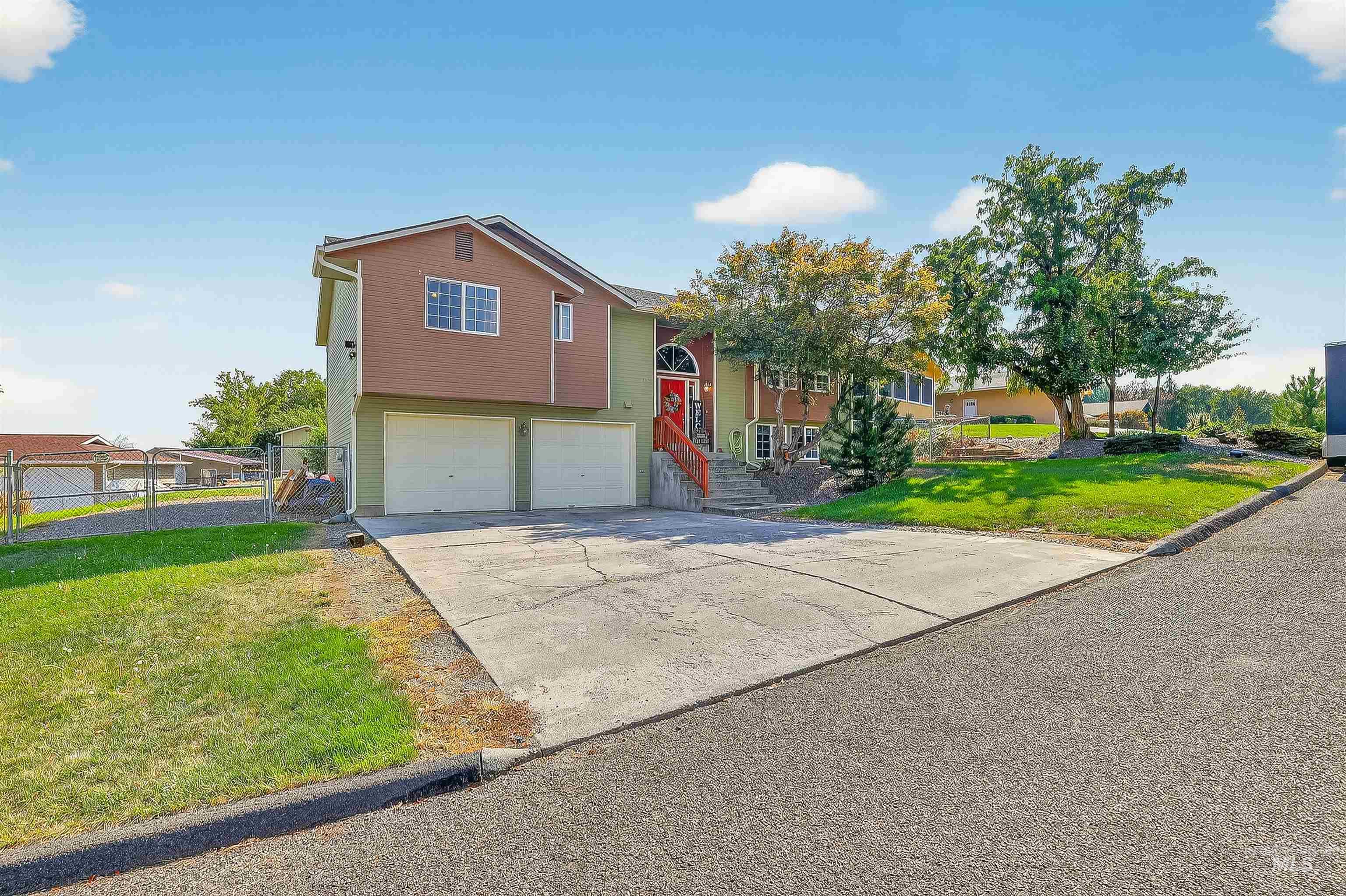 Bi-level home with concrete driveway and a garage