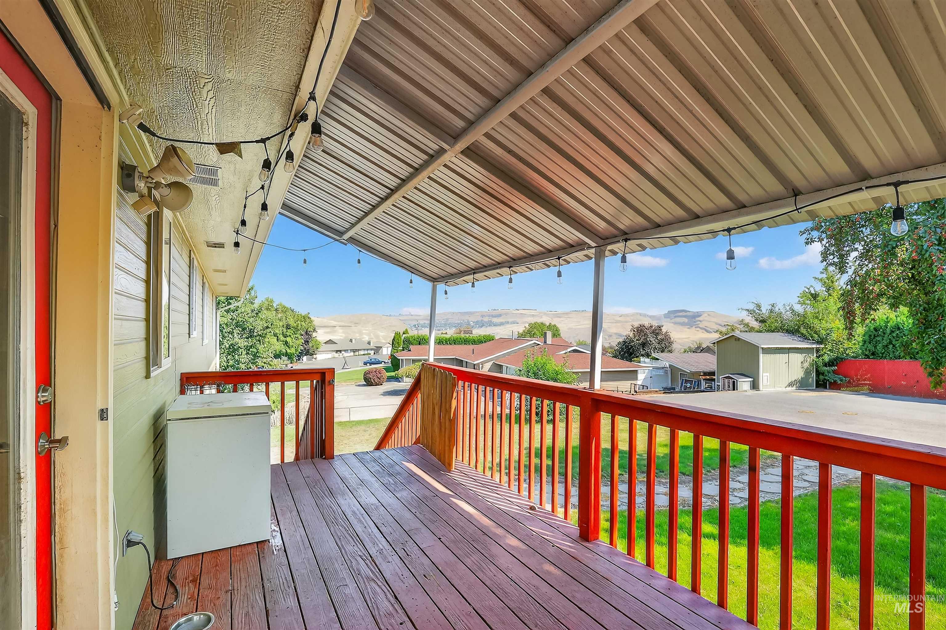 Wooden deck with a lawn and a mountain view