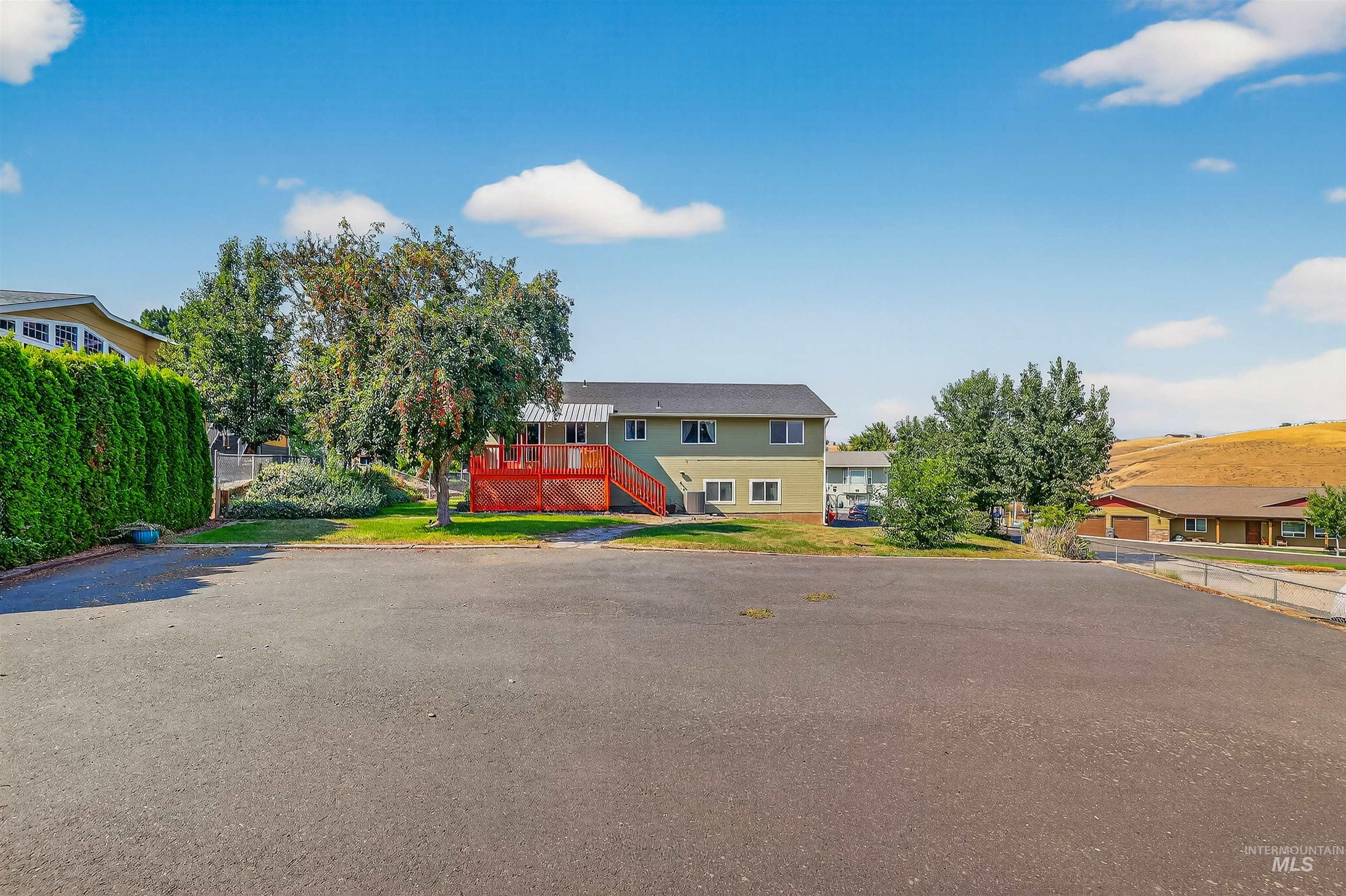 View of front of property with stairs and a deck