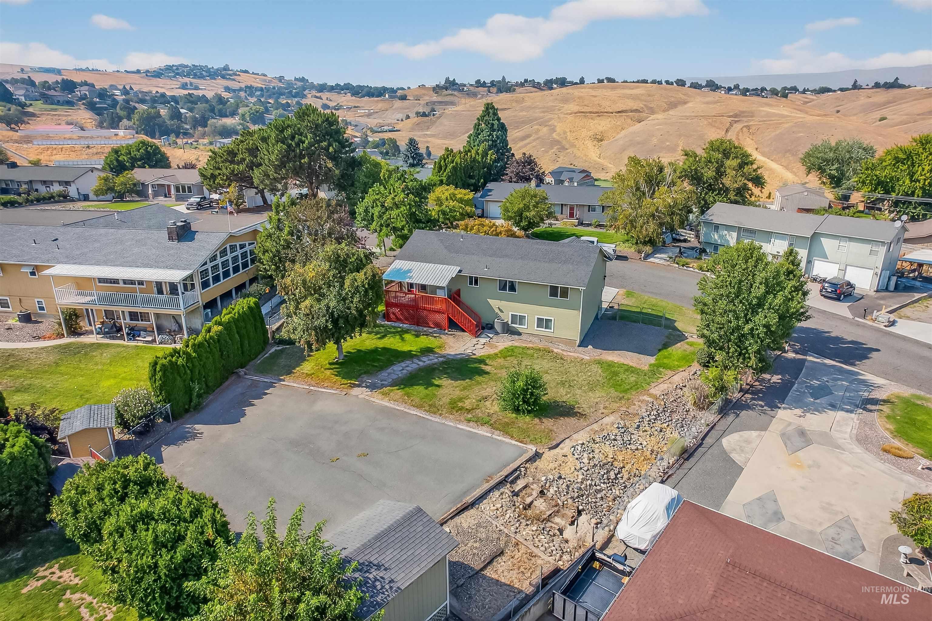 Aerial view of residential area featuring a mountainous background