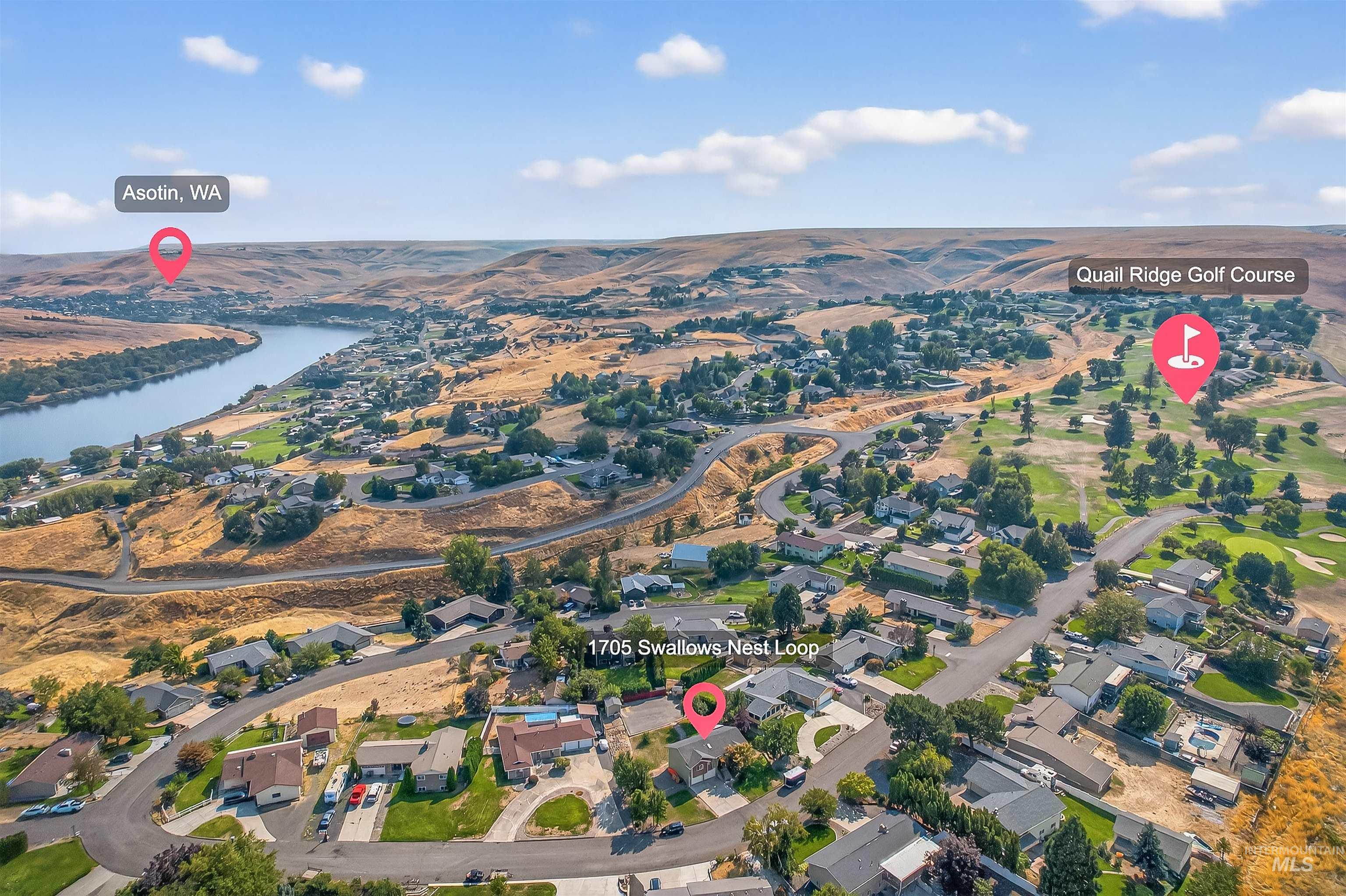 View of property location featuring nearby suburban area and a large body of water