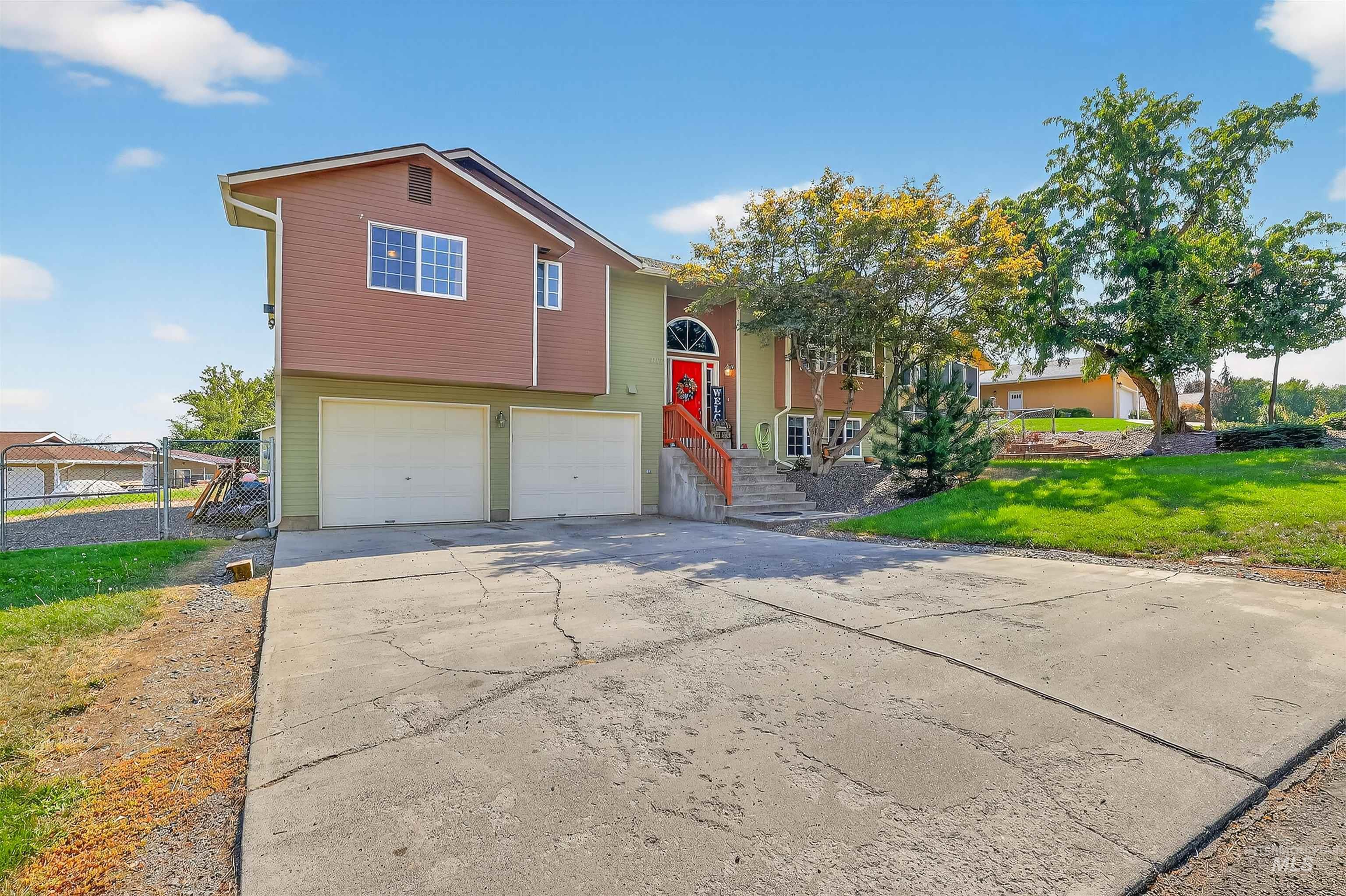 Raised ranch with a garage and concrete driveway