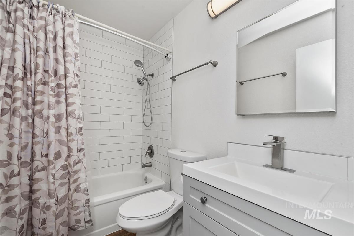 Bathroom featuring shower / bath combo and vanity