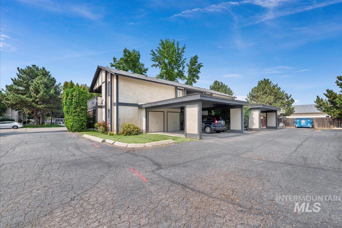 View of home's exterior with stucco siding and covered parking