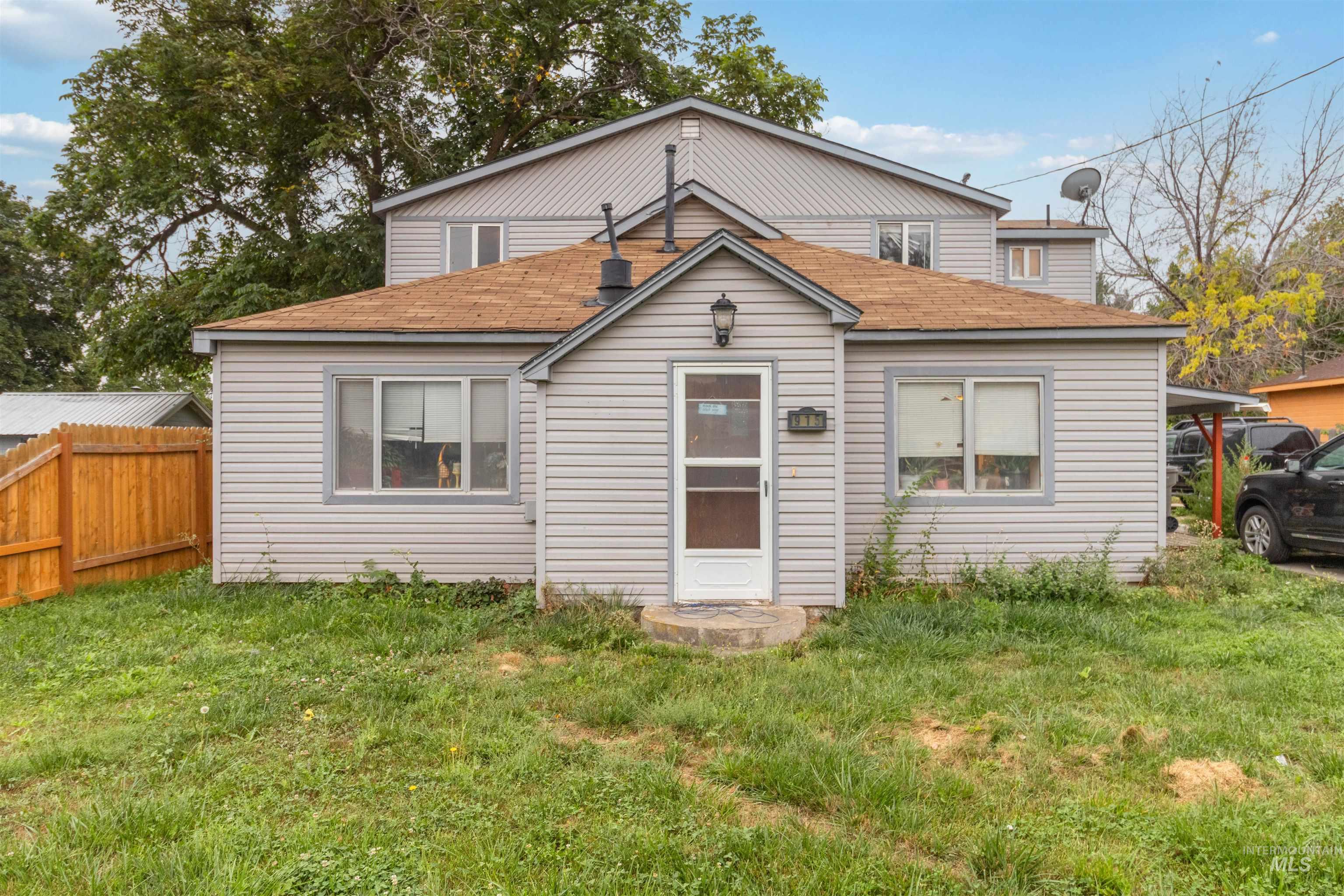 View of front of property with roof with shingles