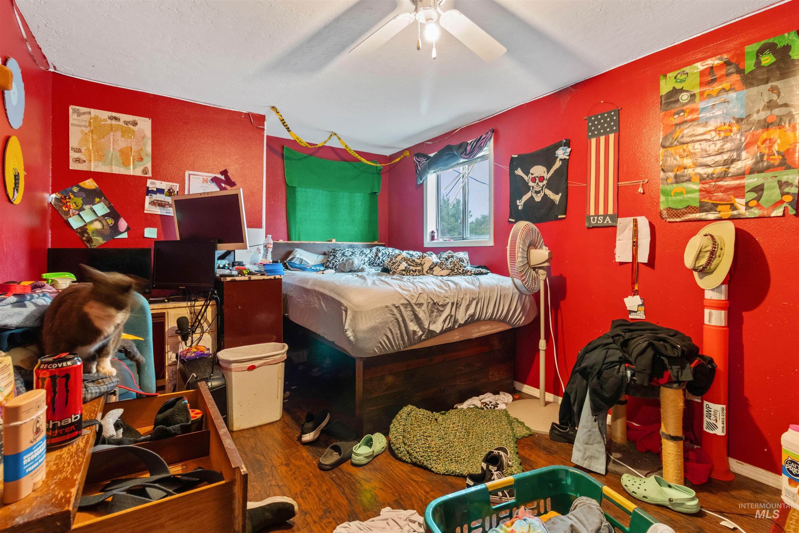 Bedroom featuring wood finished floors, ceiling fan, and a textured ceiling