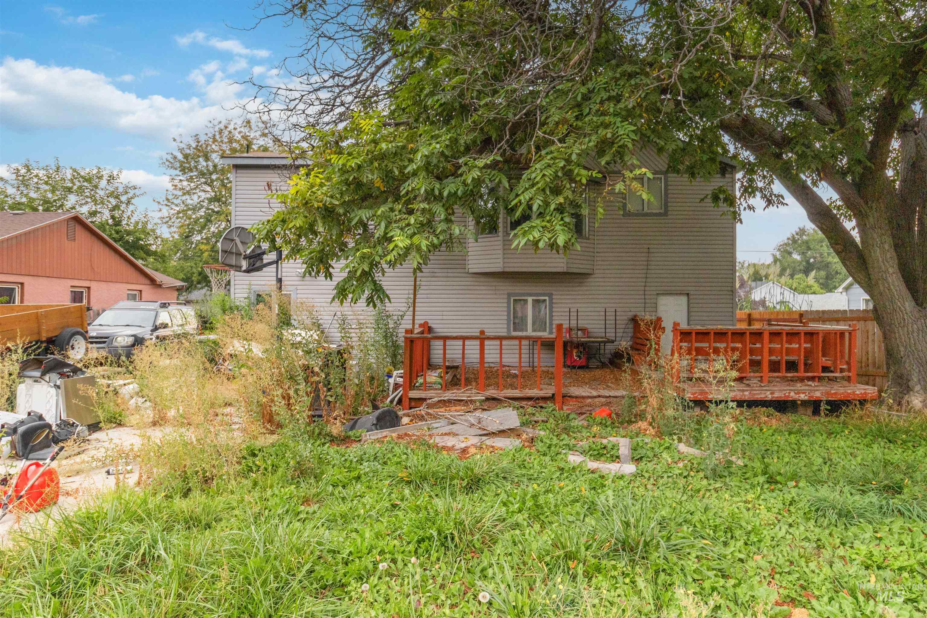 Back of house with a deck