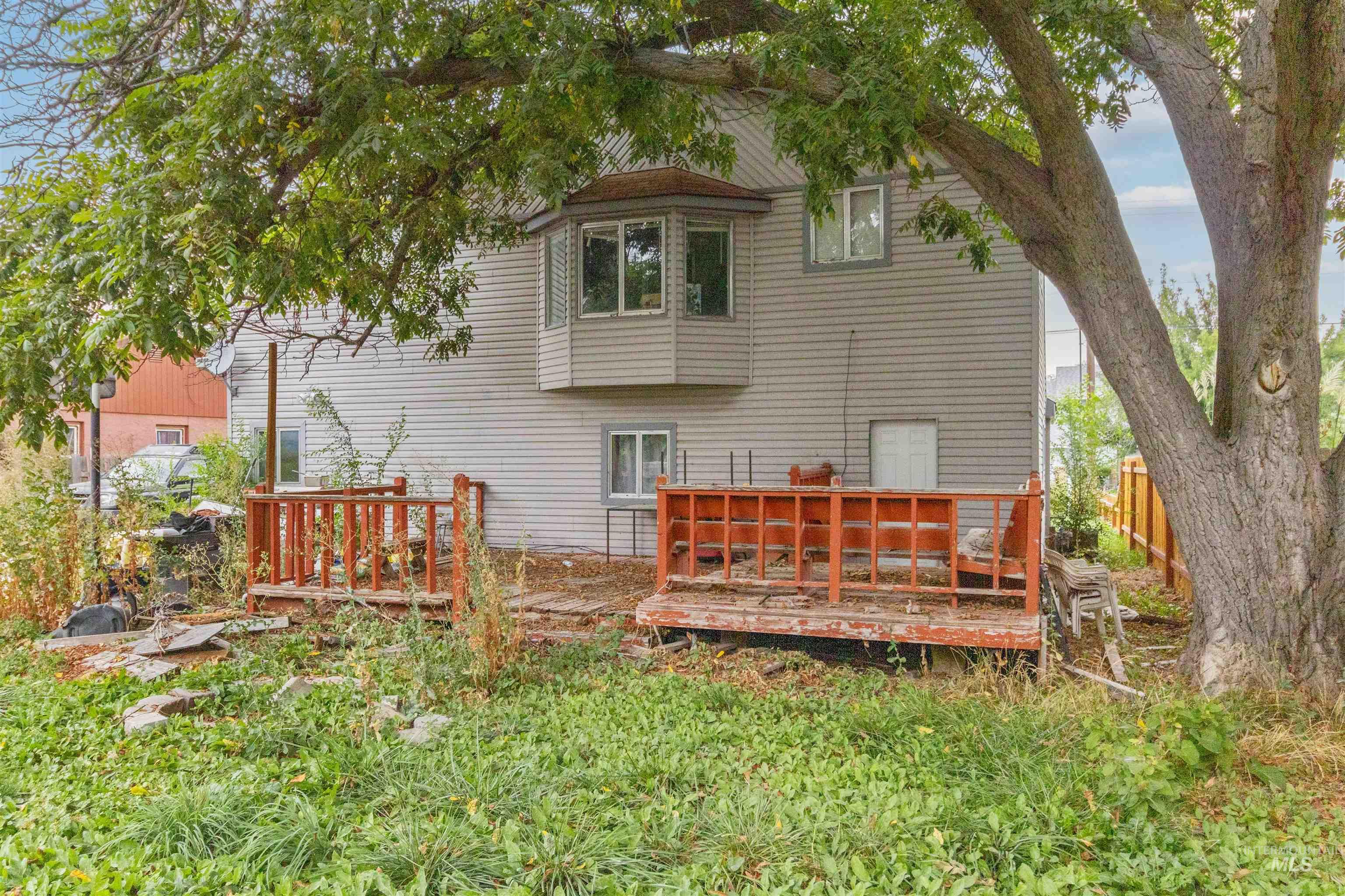 Rear view of property featuring a wooden deck