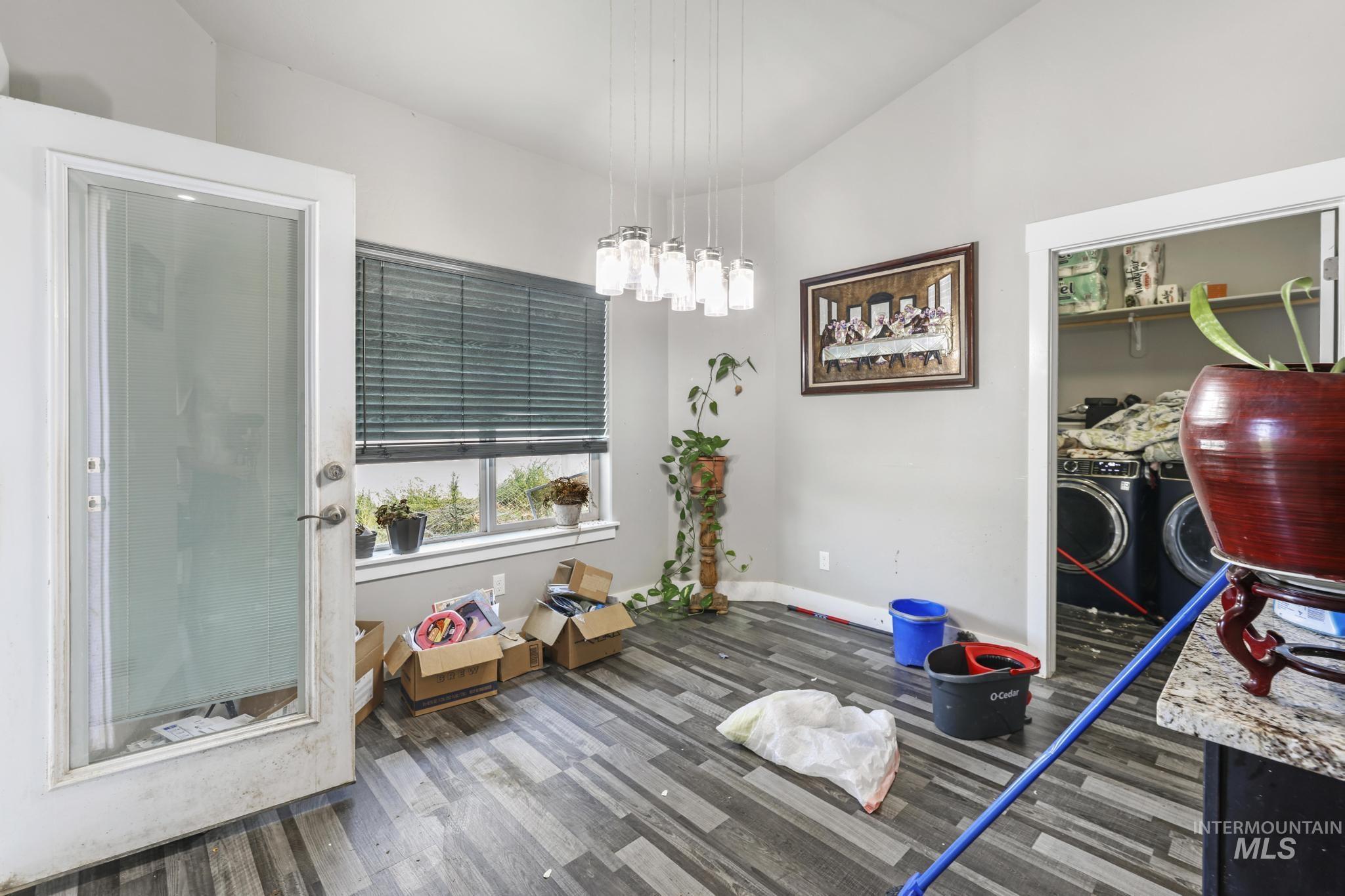 Dining room with dark wood-style flooring and washer and clothes dryer
