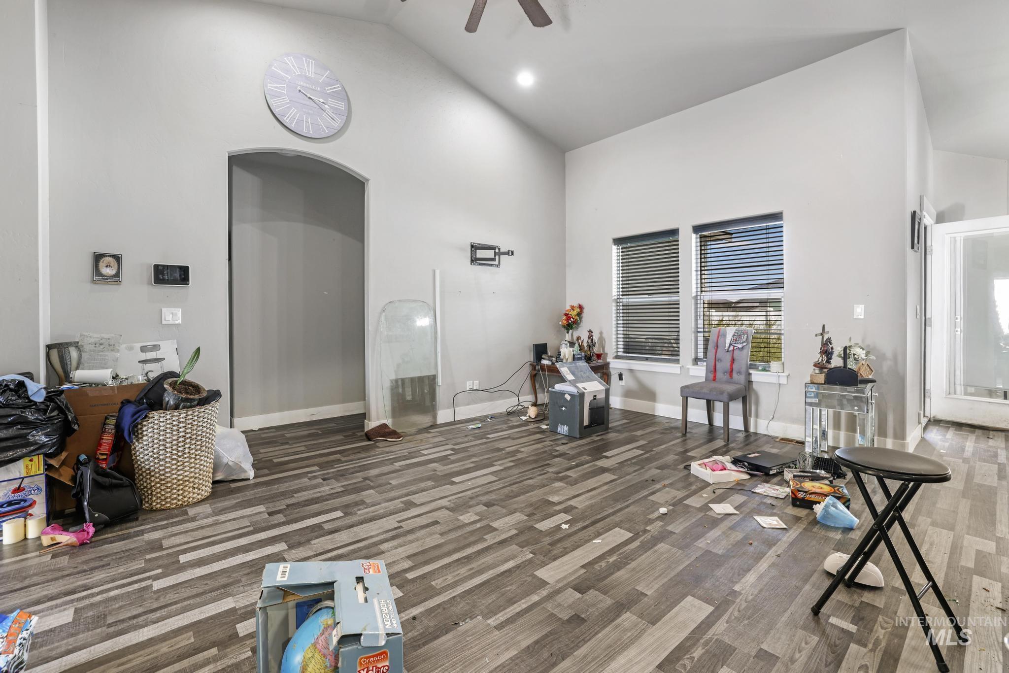 Living room featuring high vaulted ceiling, ceiling fan, recessed lighting, and wood finished floors