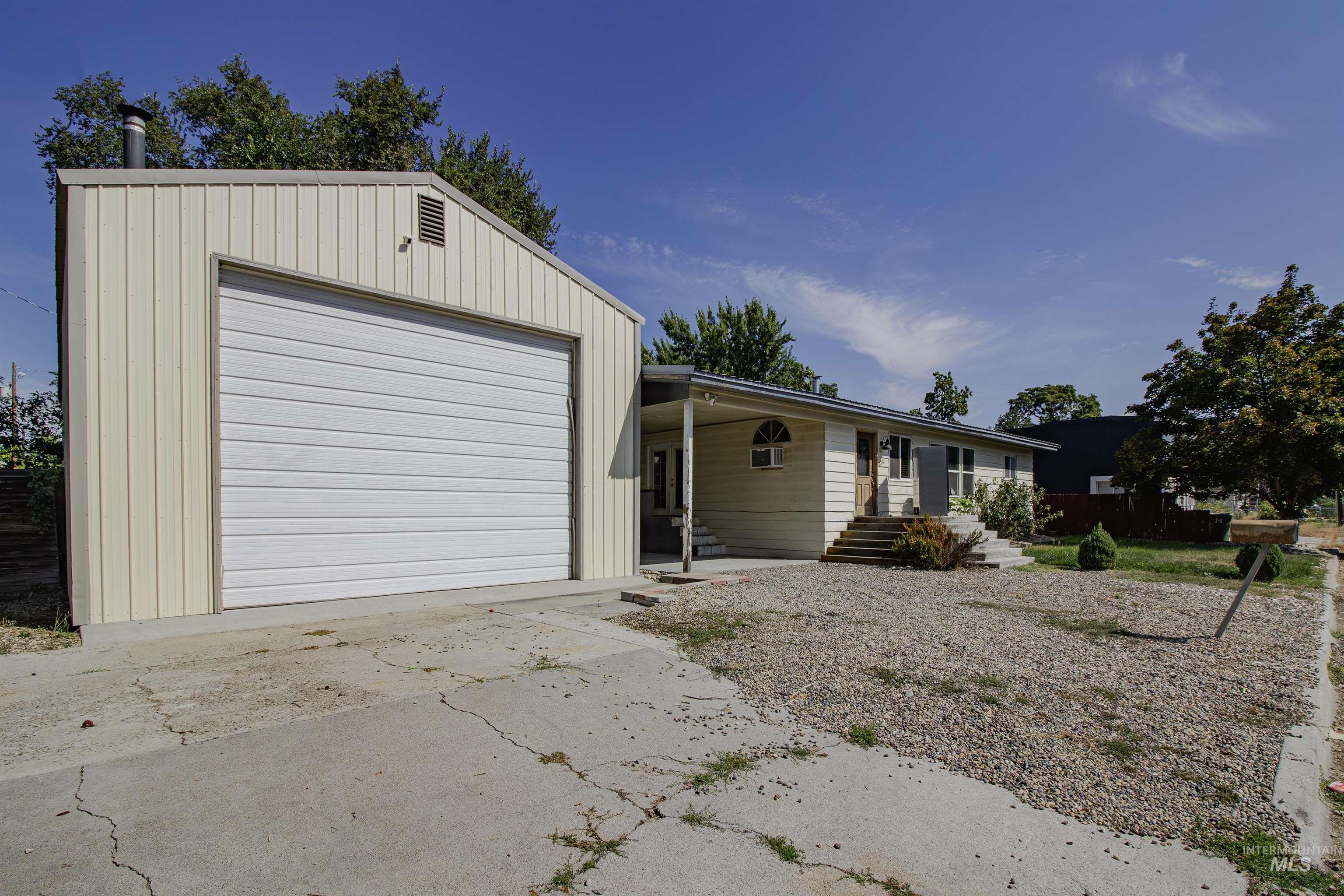 View of front of house with concrete driveway and board and batten siding