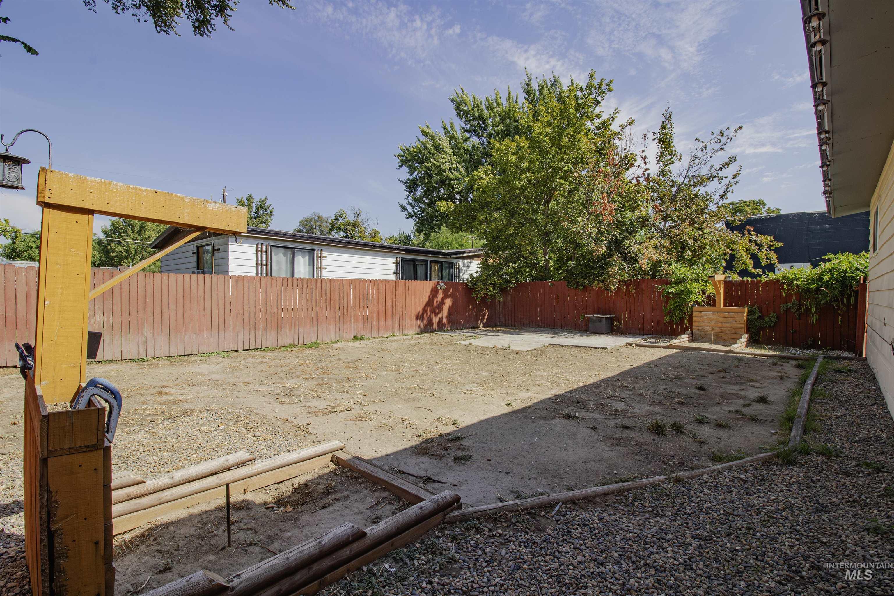 Fenced backyard with a patio
