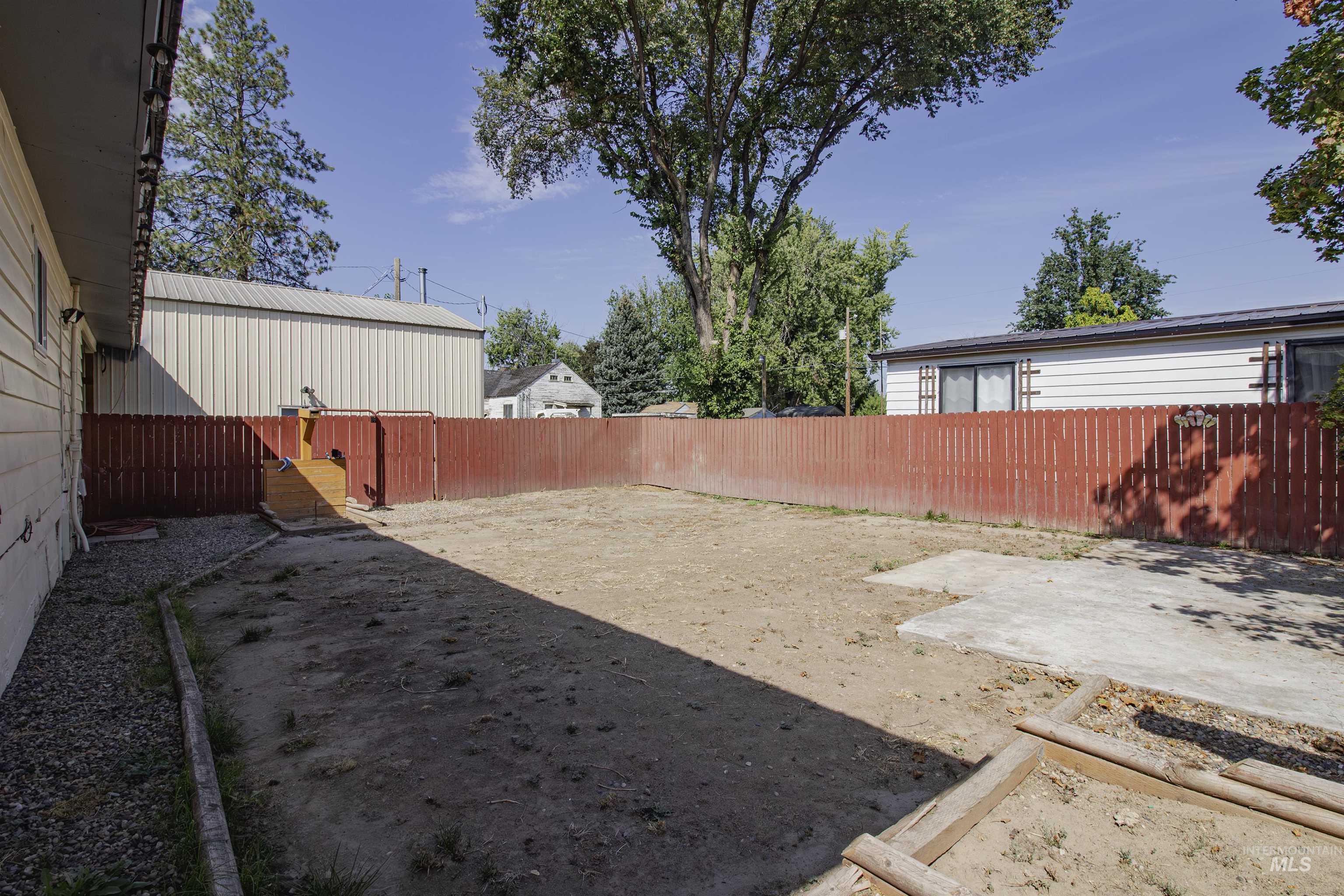 Fenced backyard with a patio area