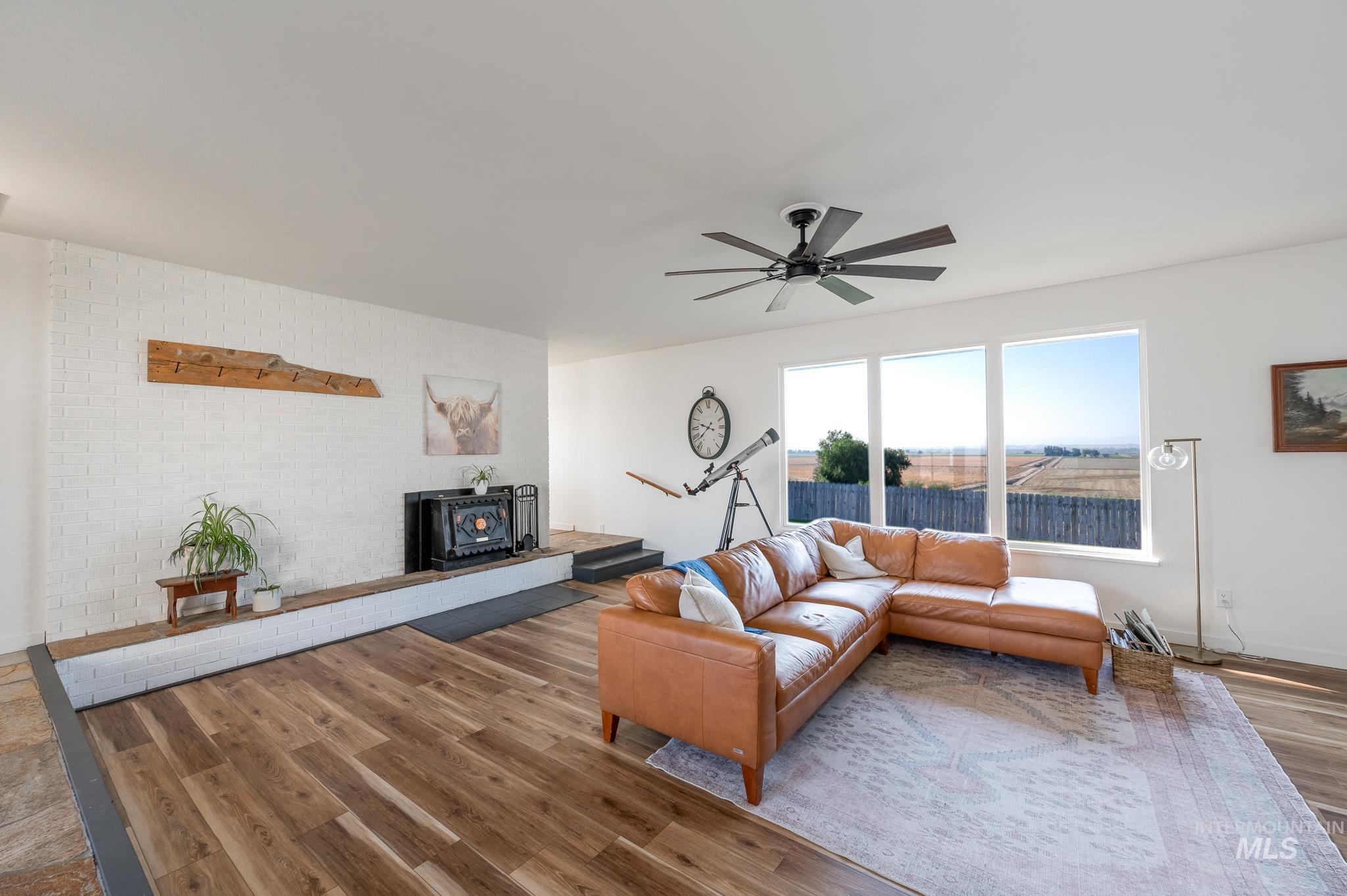 Living area with wood finished floors and a ceiling fan