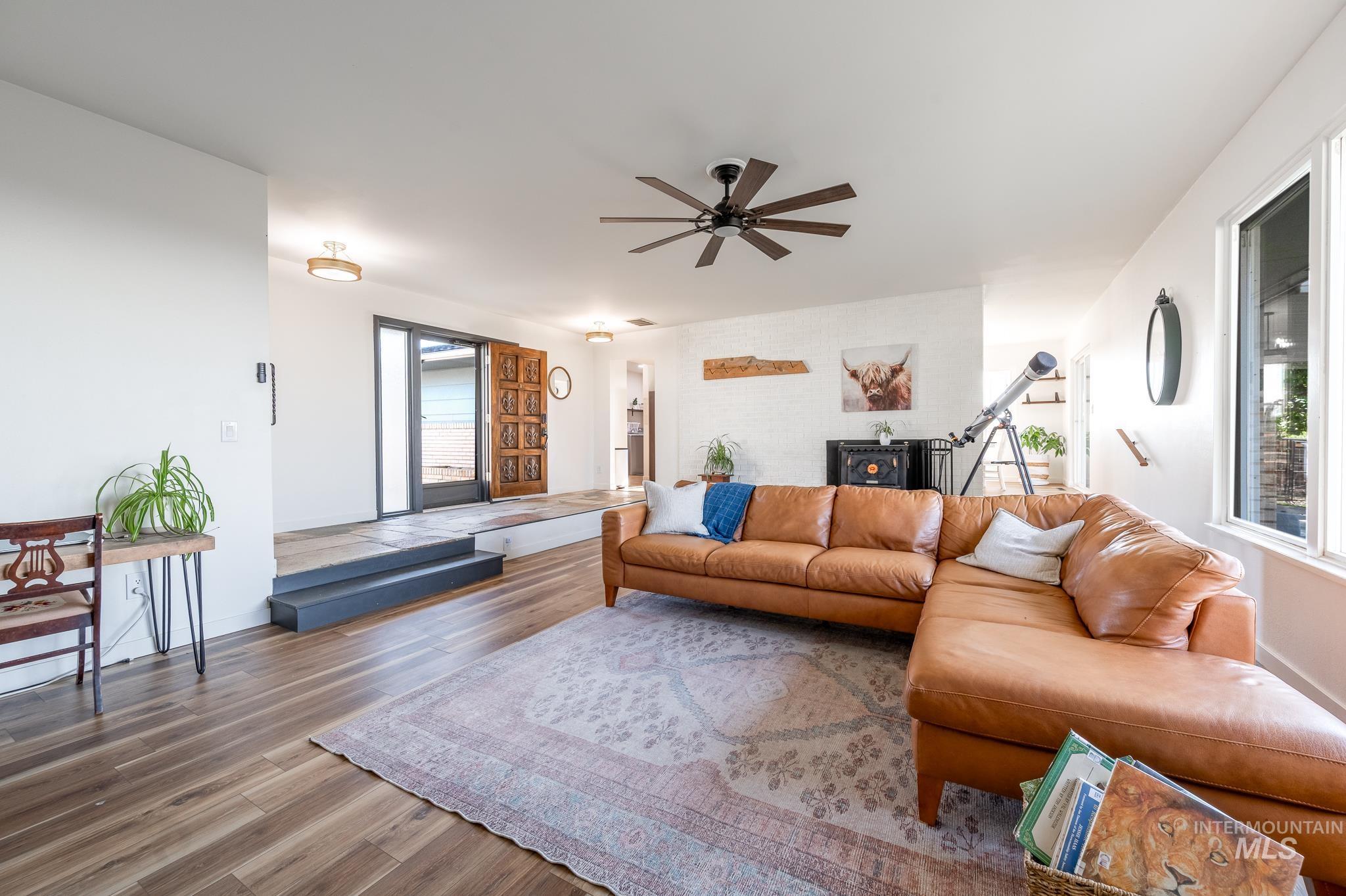 Living area with wood finished floors and ceiling fan