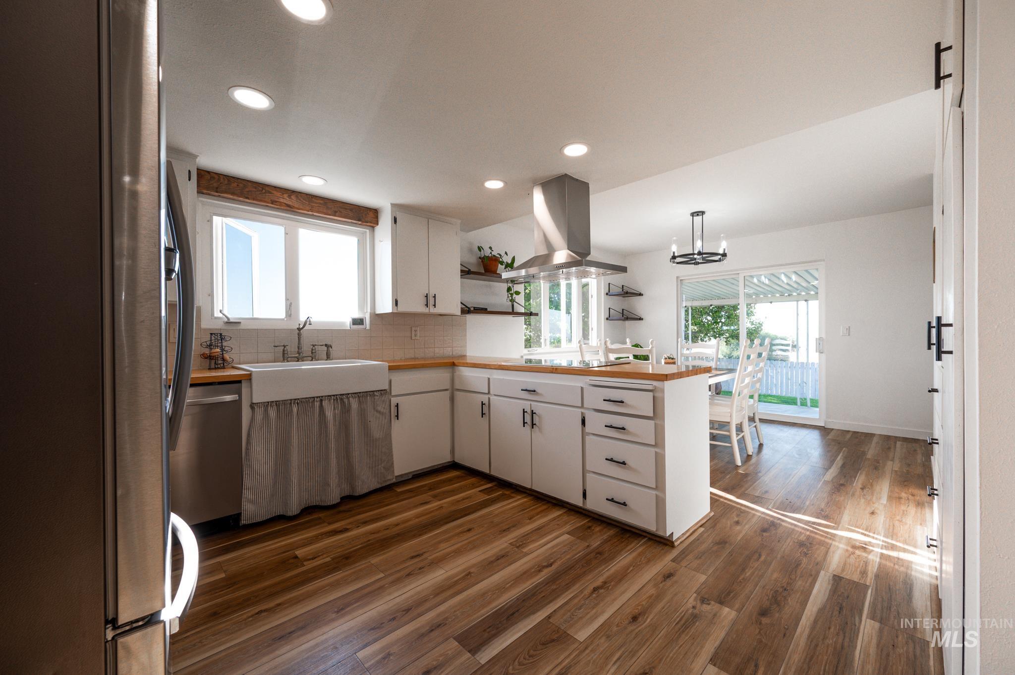 Kitchen with open shelves, white cabinetry, stainless steel appliances, recessed lighting, and plenty of natural light