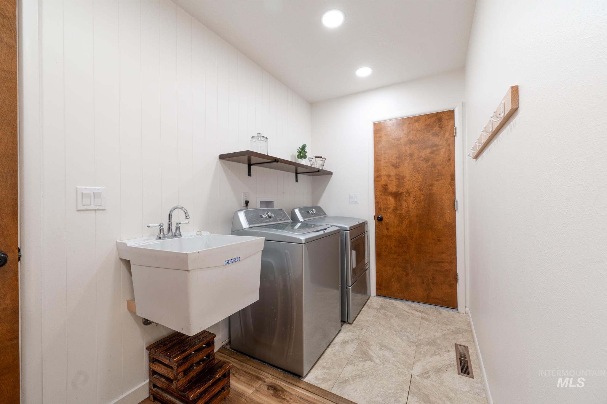 Laundry area with washing machine and clothes dryer, recessed lighting, and light tile patterned floors