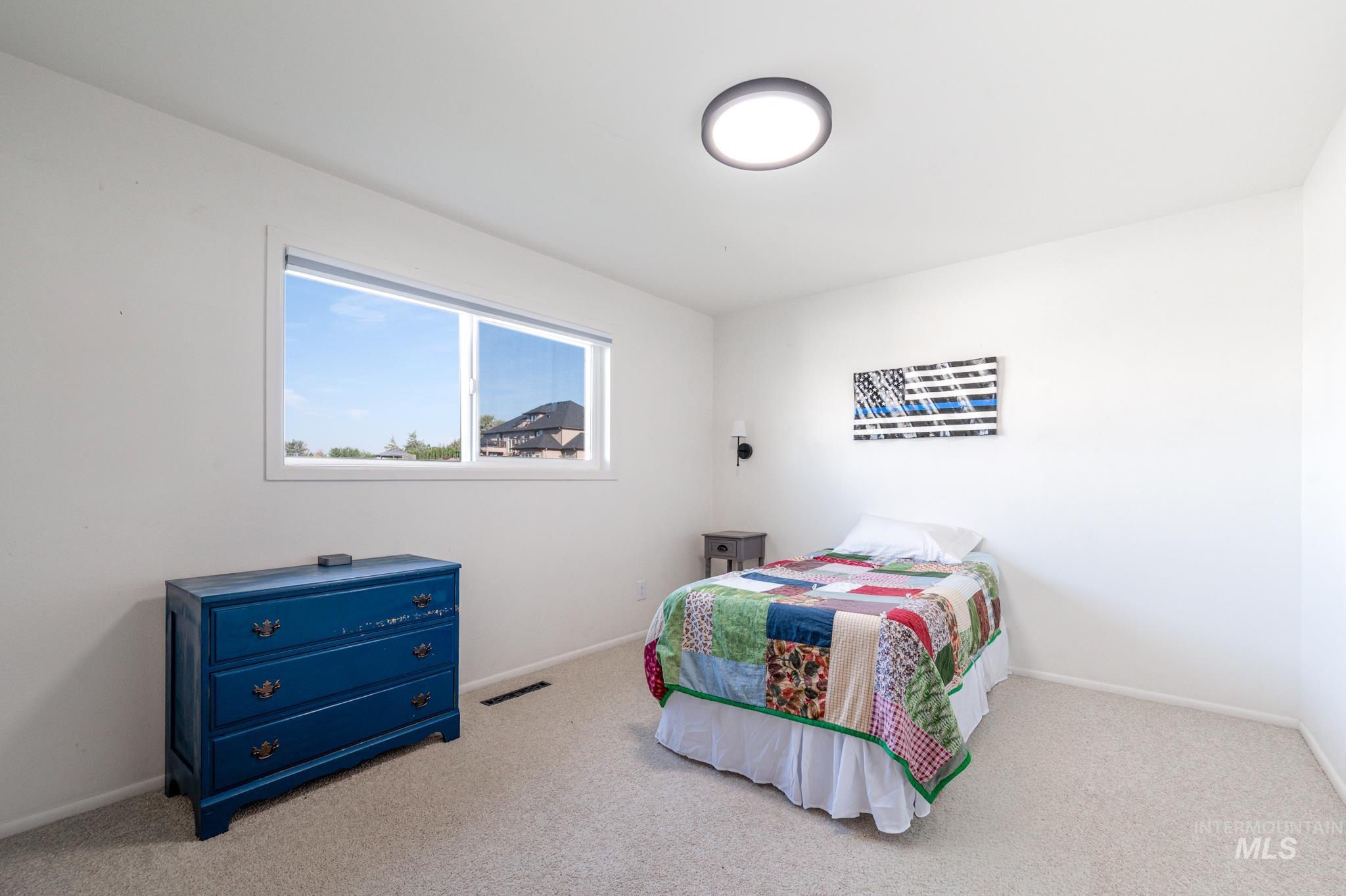 Bedroom featuring carpet flooring and baseboards