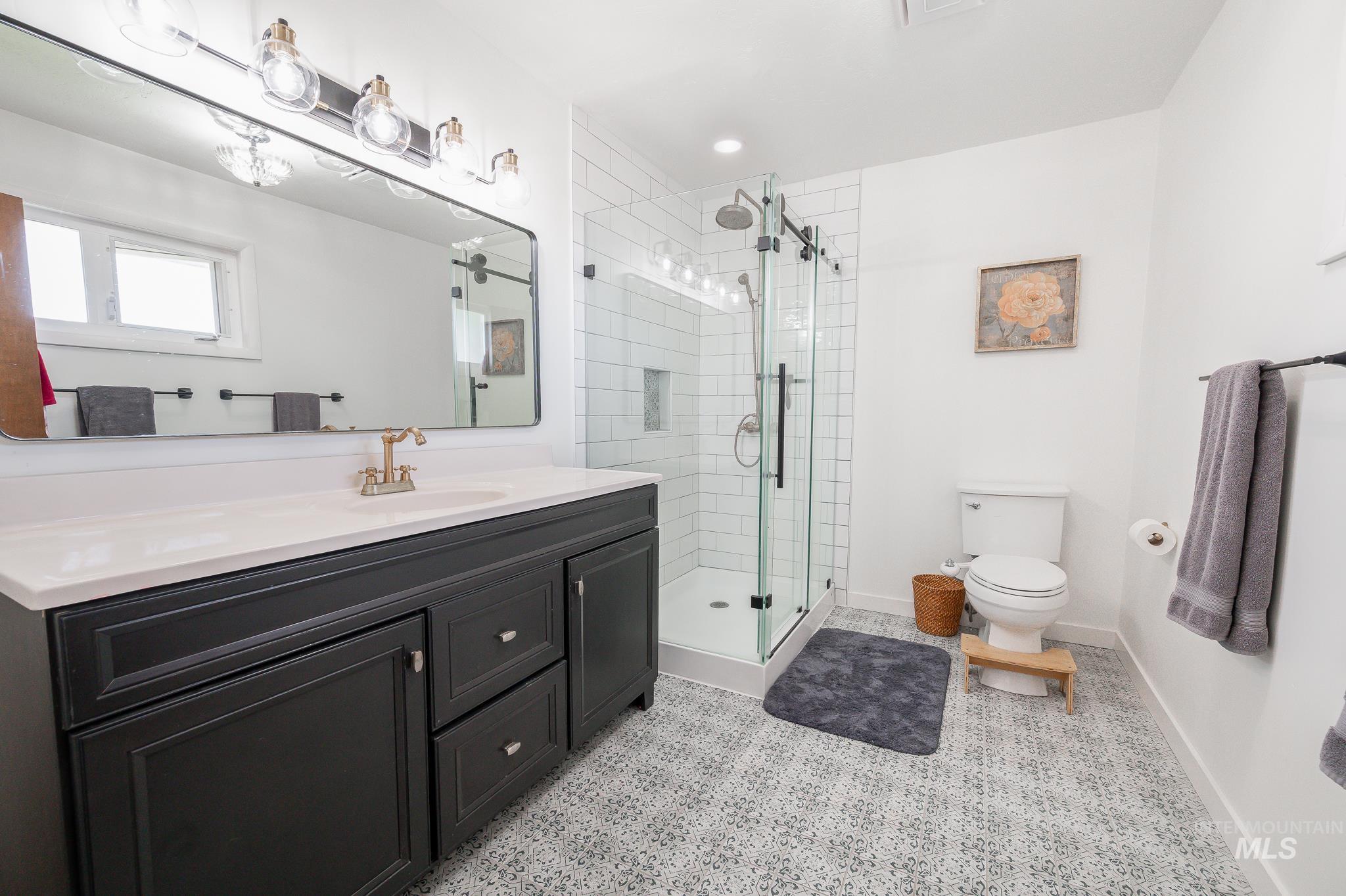 Bathroom with vanity, a stall shower, and recessed lighting
