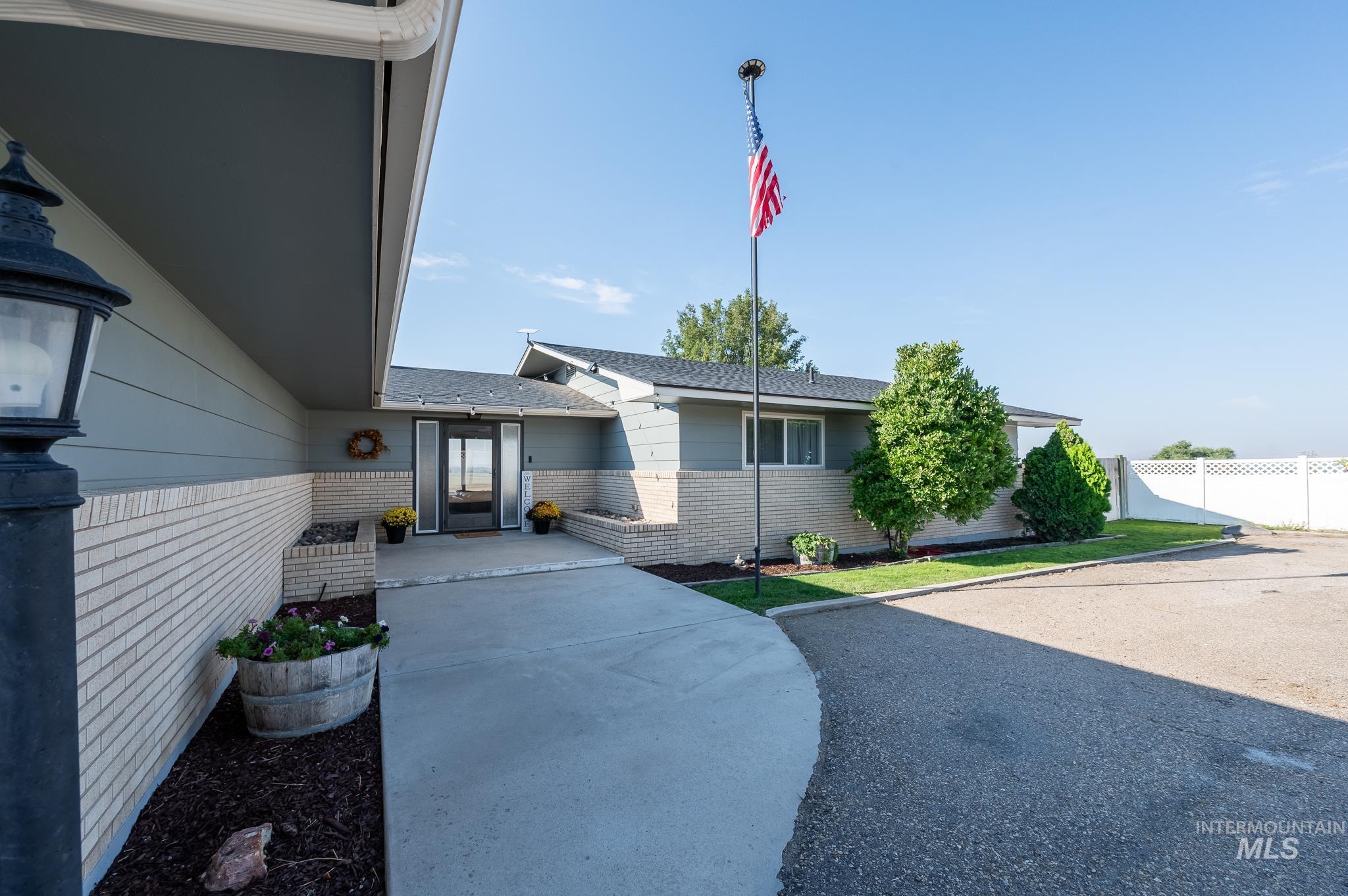 Property entrance featuring brick siding and roof with shingles
