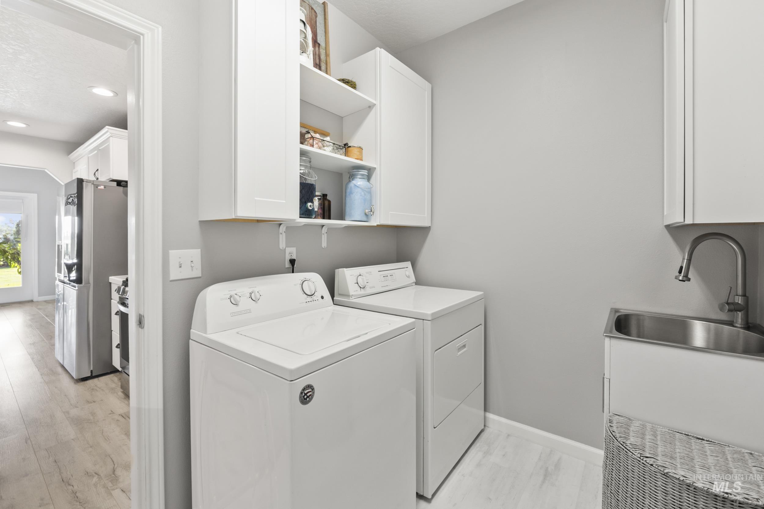 Washroom with separate washer and dryer, recessed lighting, and cabinet space
