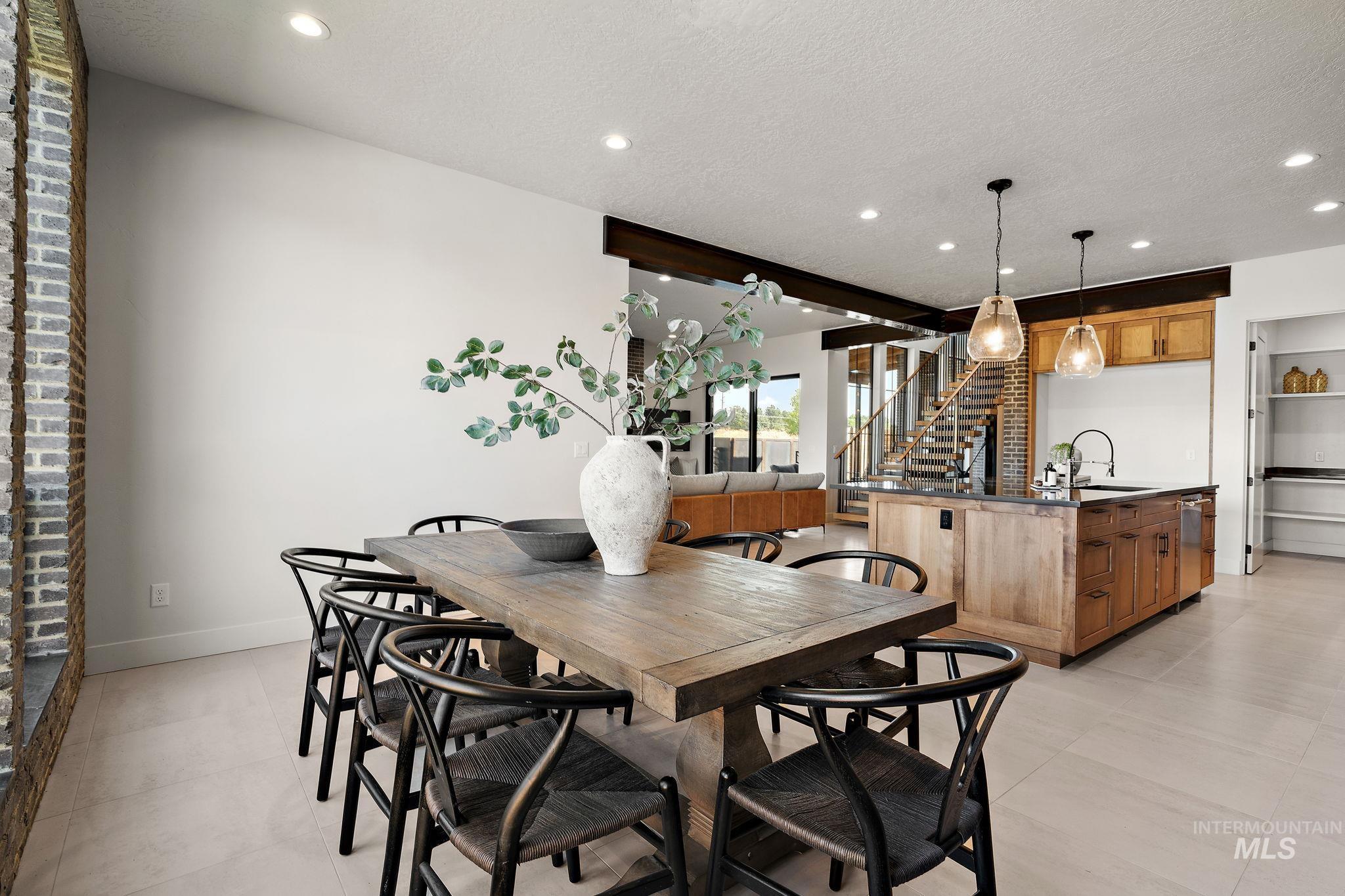 Dining space featuring stairway, a textured ceiling, recessed lighting, and light tile patterned floors