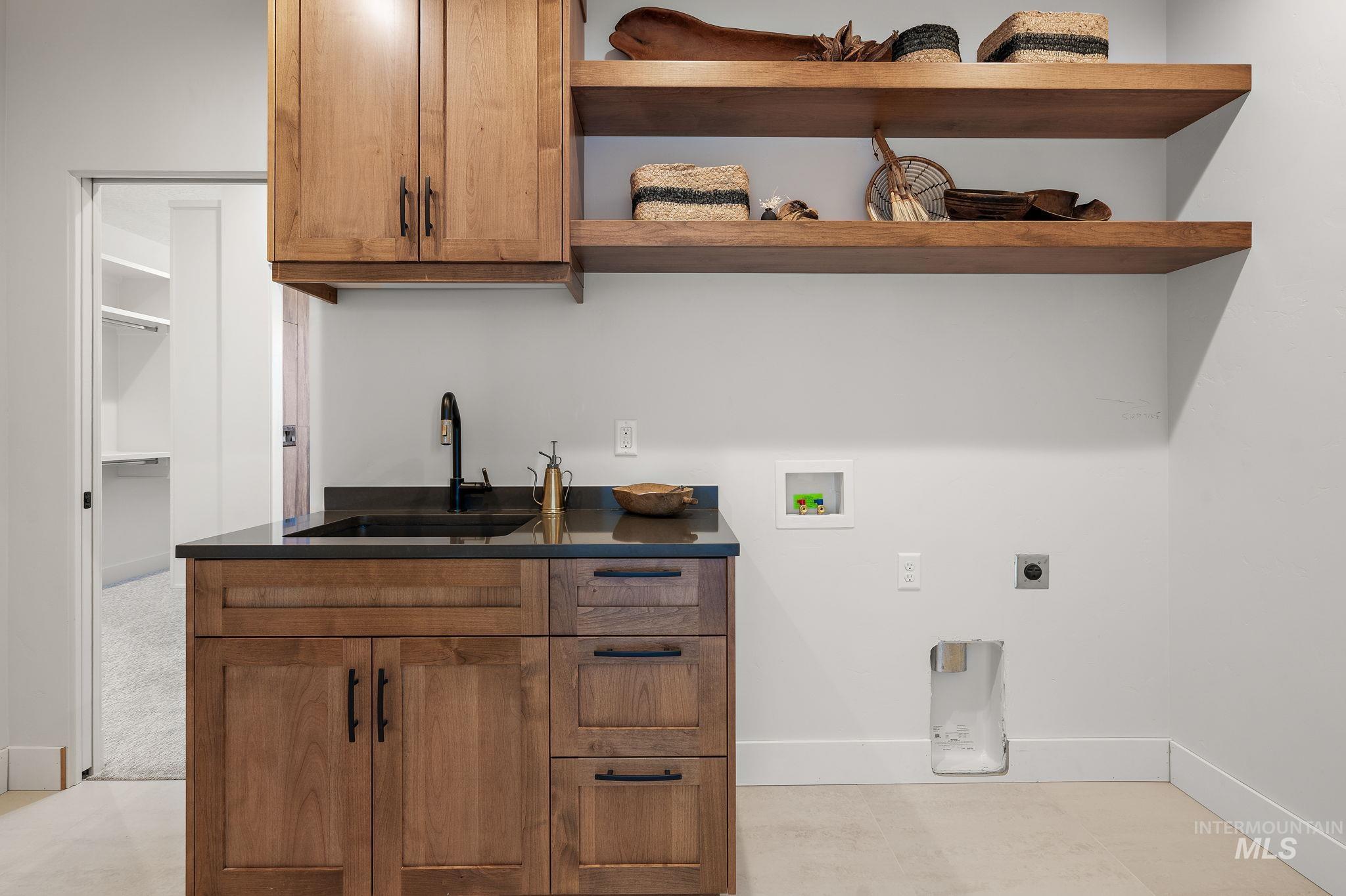 Laundry area with hookup for a washing machine, hookup for an electric dryer, and cabinet space
