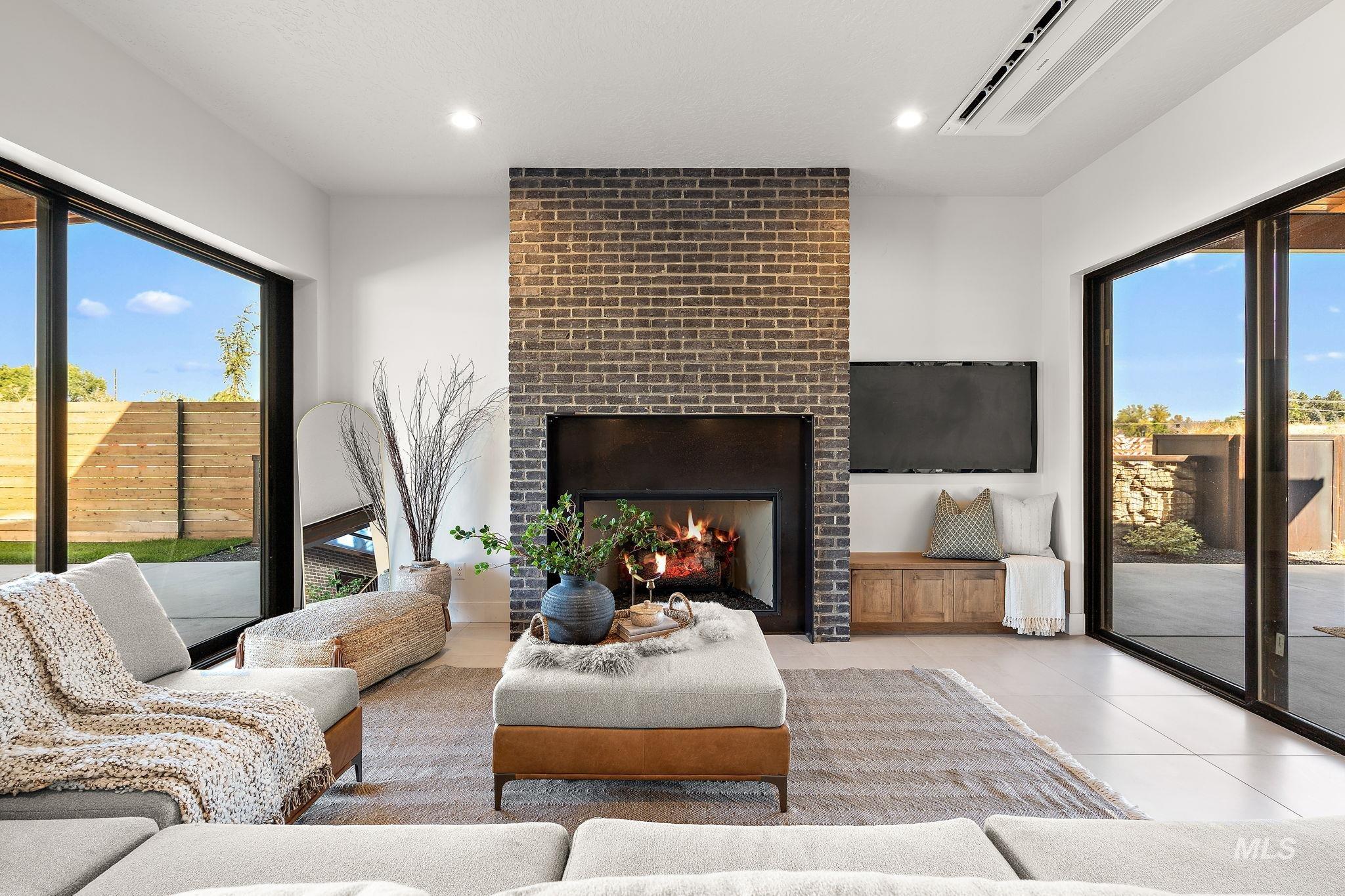 Living area with a fireplace, tile patterned floors, and recessed lighting