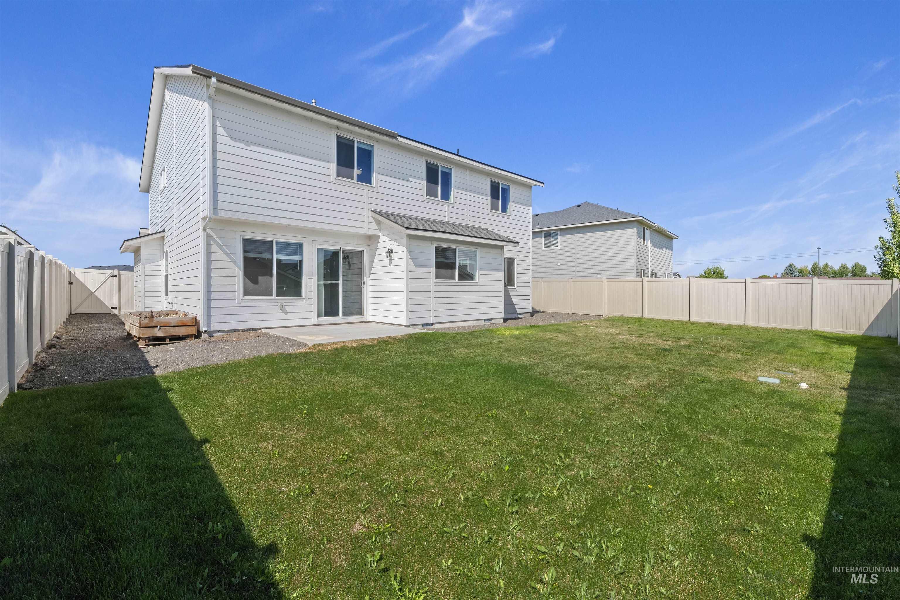 Rear view of property featuring a patio and a fenced backyard