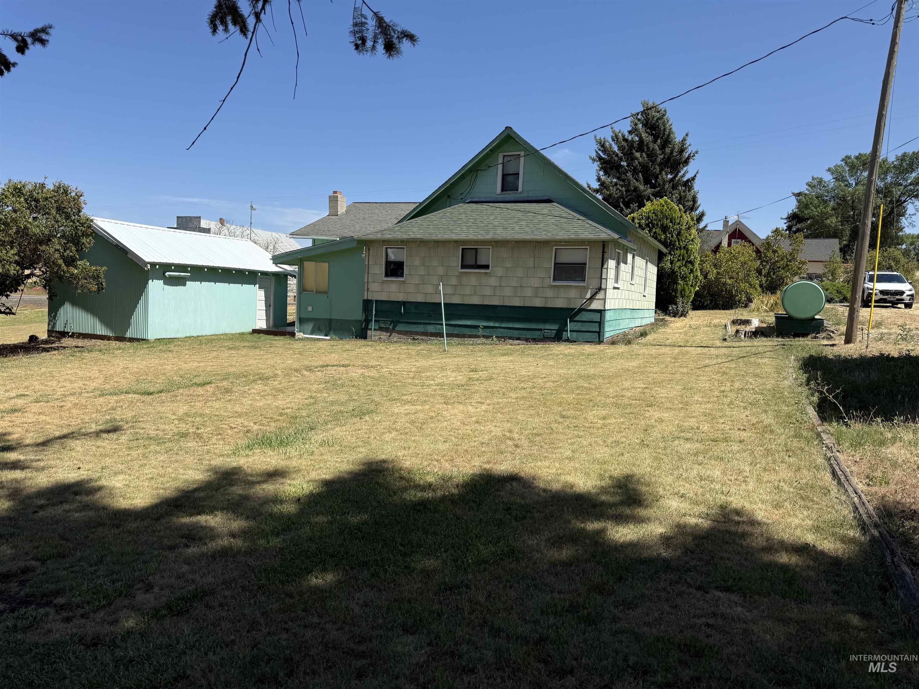 Rear view of house with a lawn and a chimney