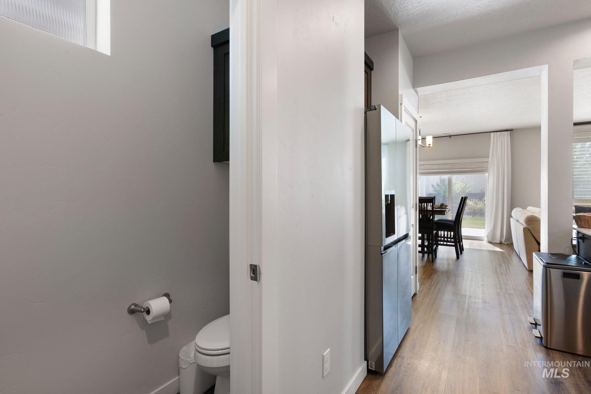 Hall featuring dark wood finished floors and baseboards