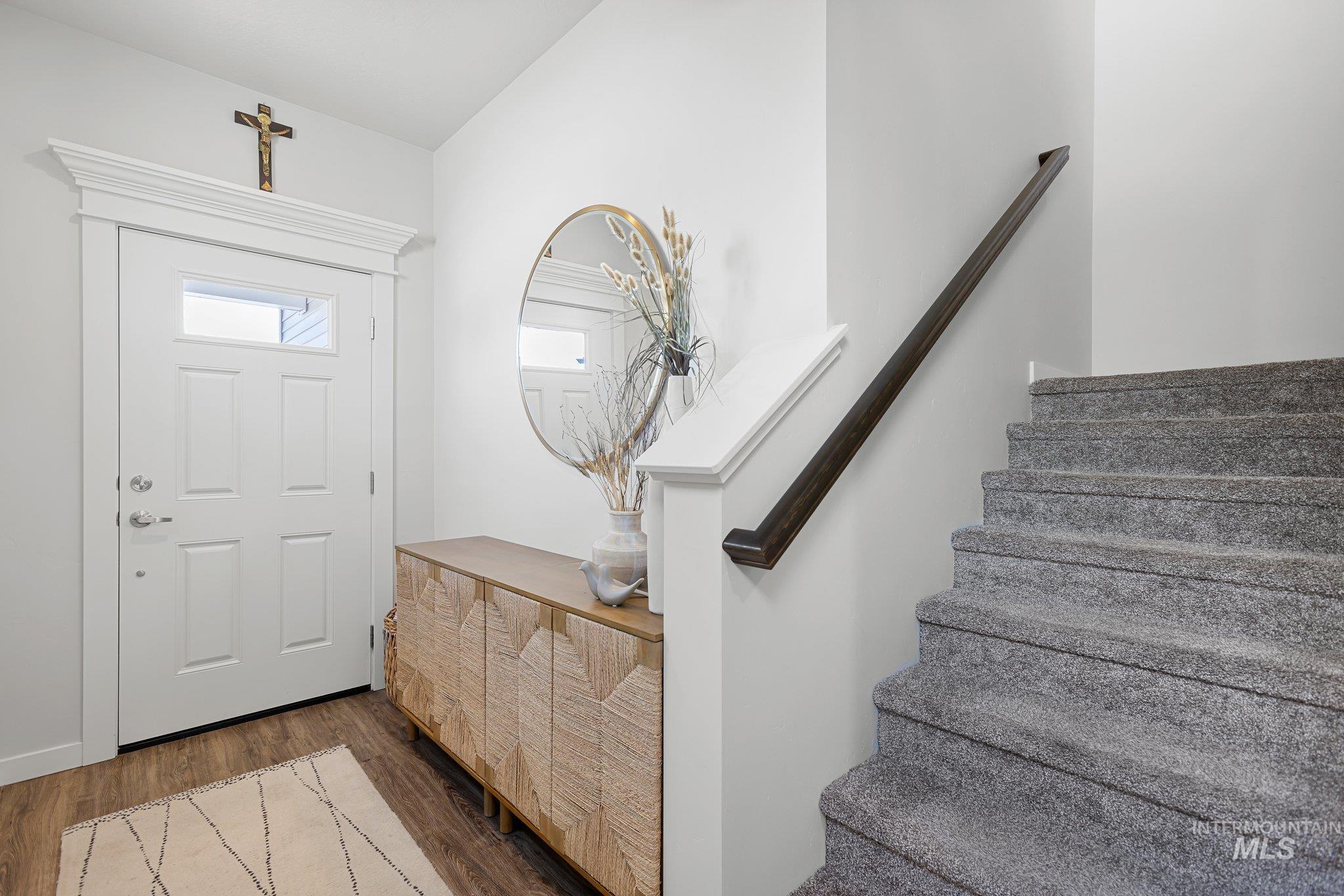 Entryway featuring dark wood-type flooring and stairway