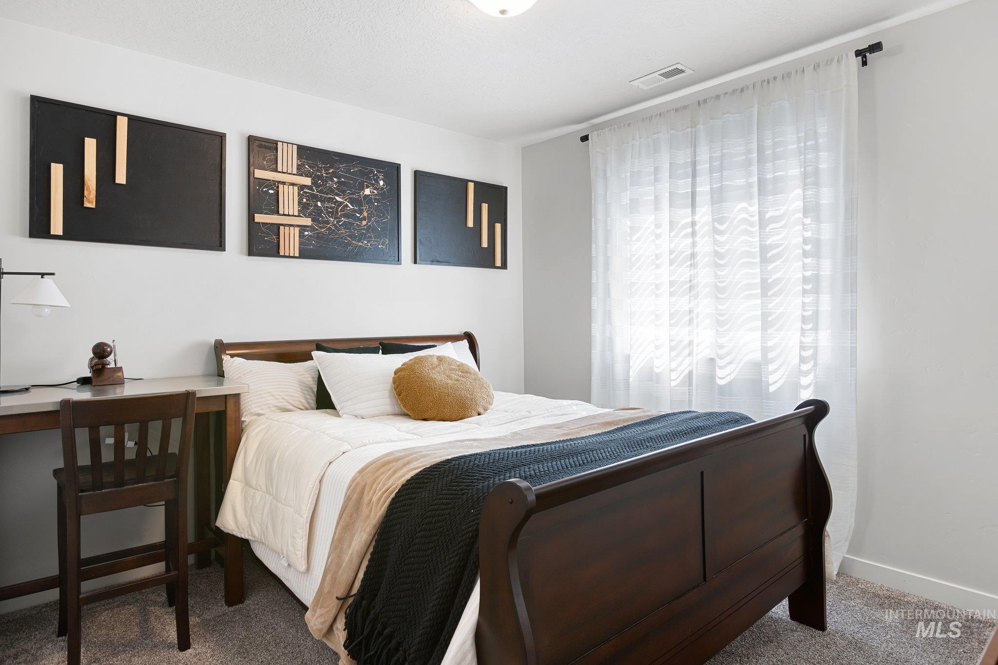 Bedroom with carpet flooring and baseboards