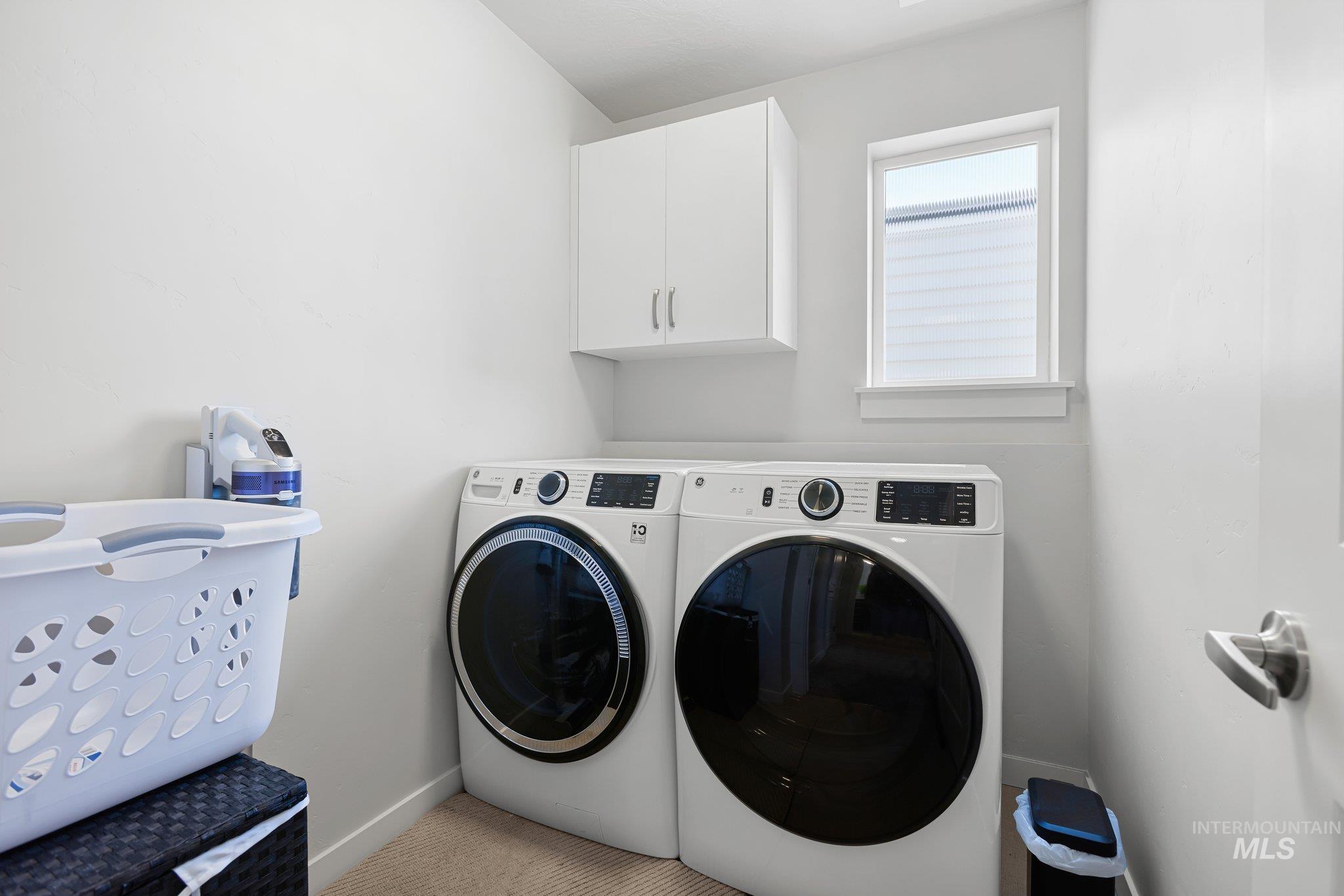 Laundry room featuring washer and dryer and cabinet space