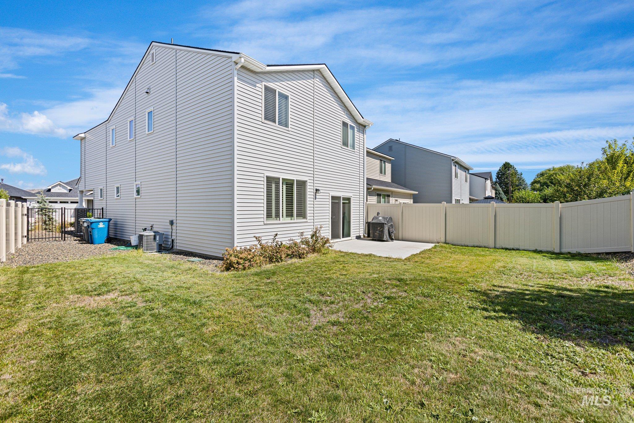 Back of property featuring a patio and a fenced backyard
