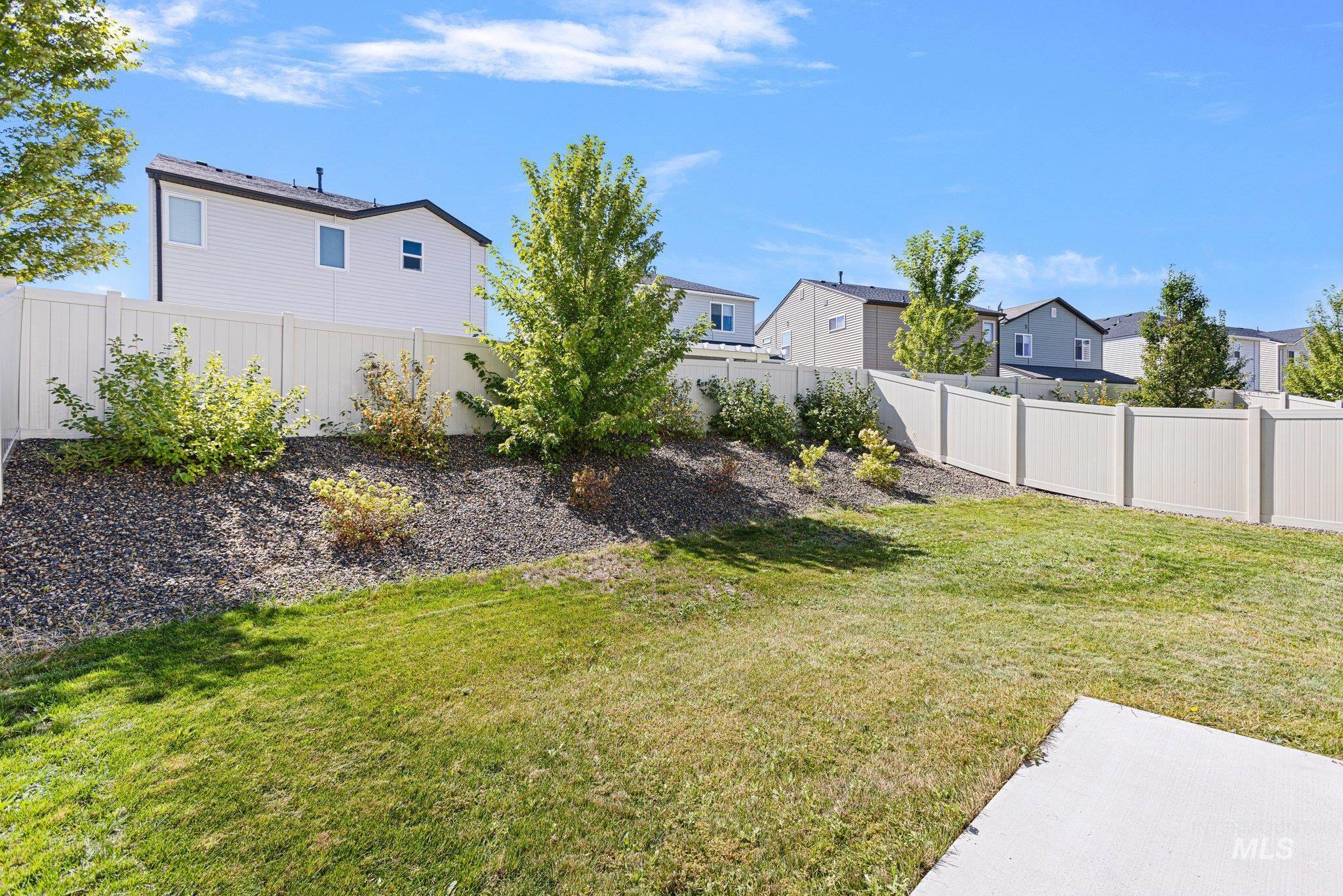 Fenced backyard with a residential view