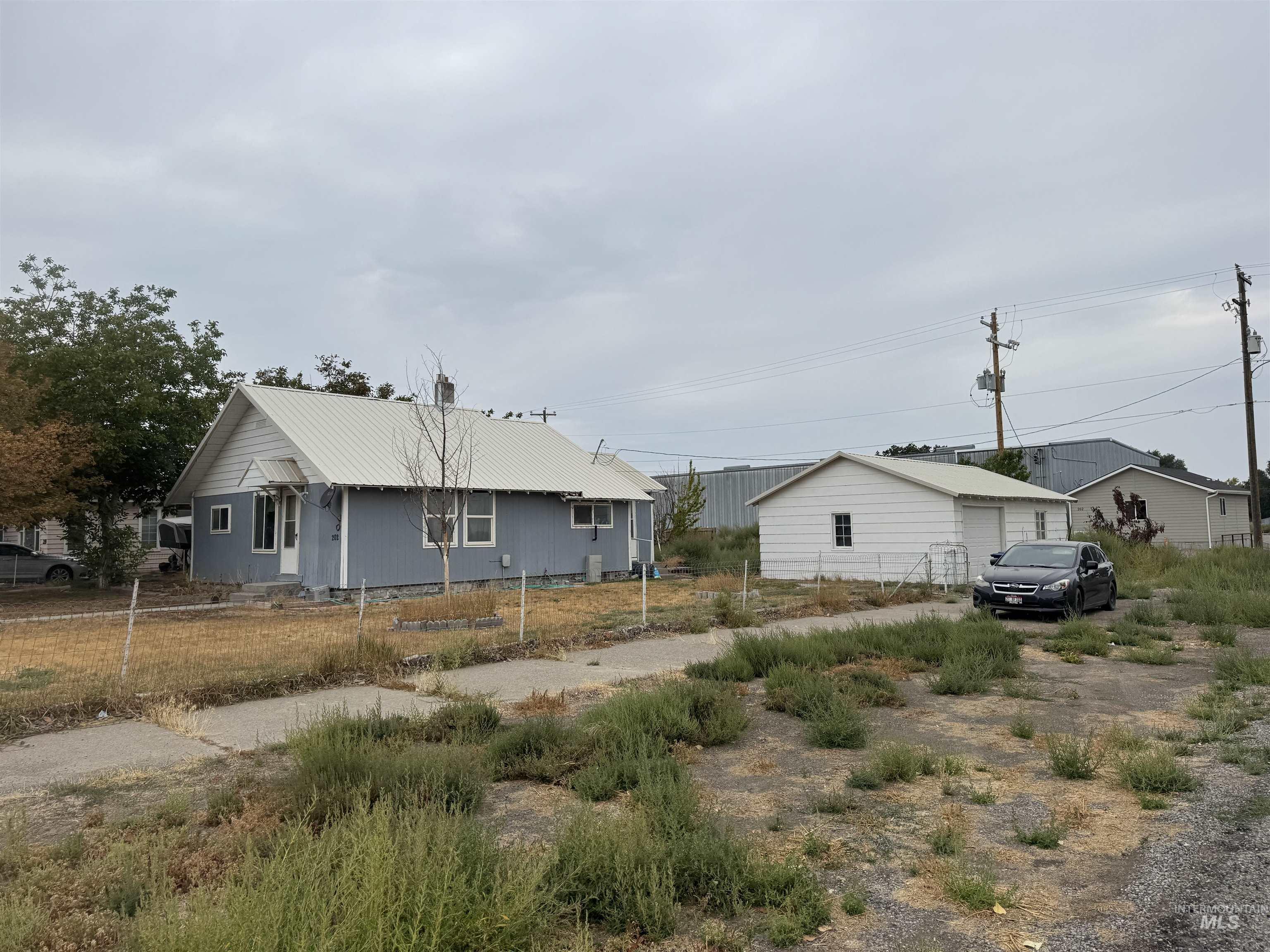 View of side of home featuring a metal roof
