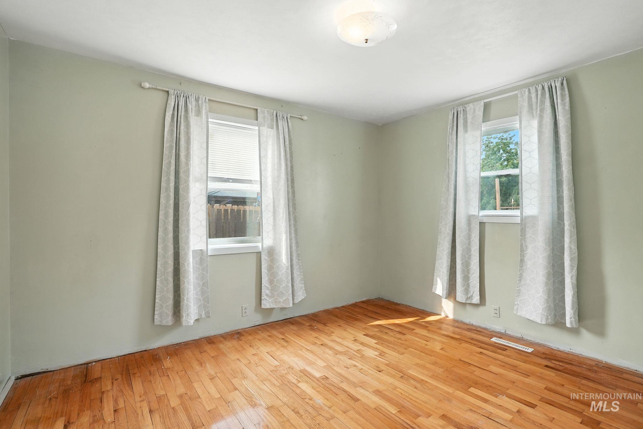 Unfurnished room featuring light wood-type flooring