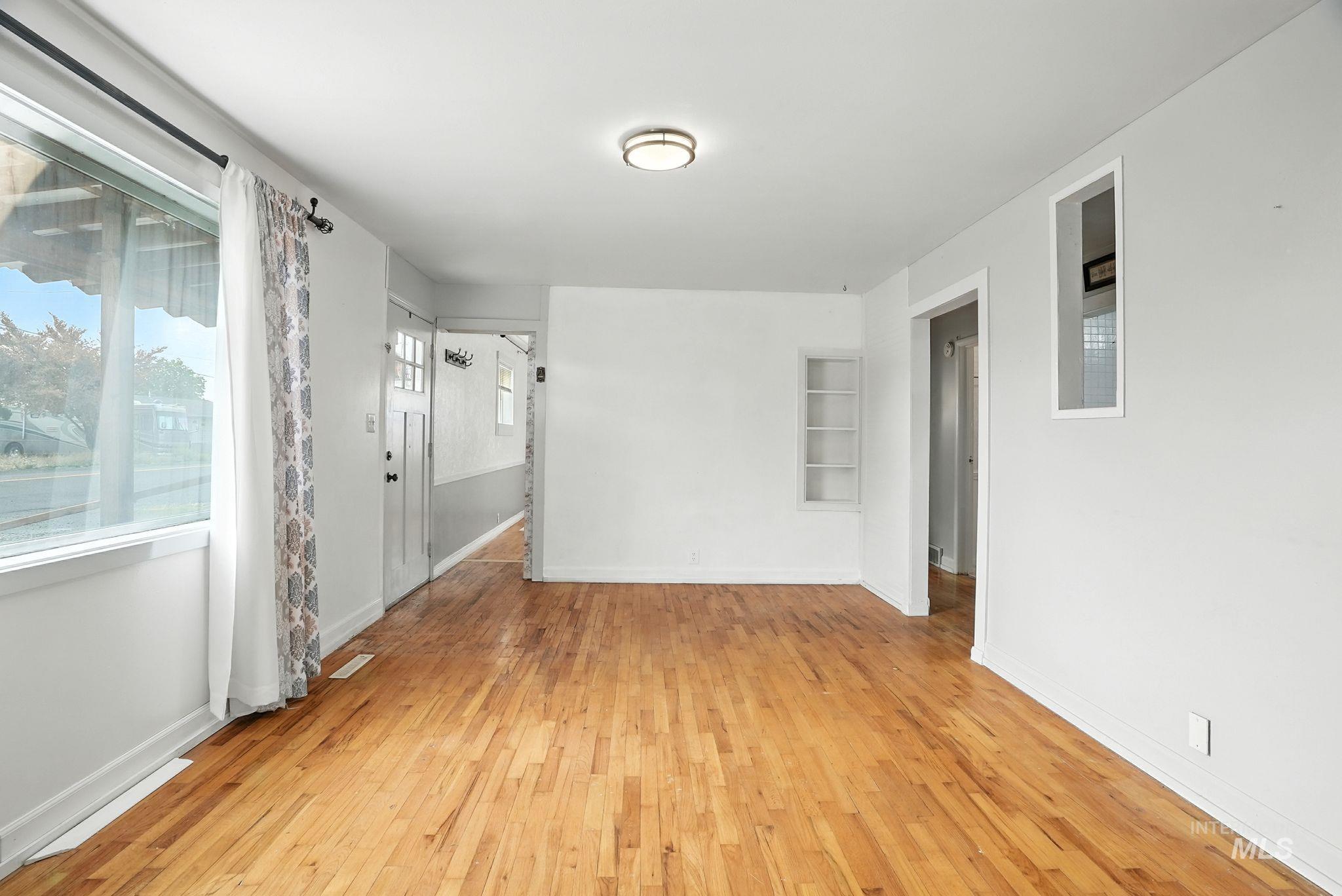 Empty room with light wood finished floors and baseboards