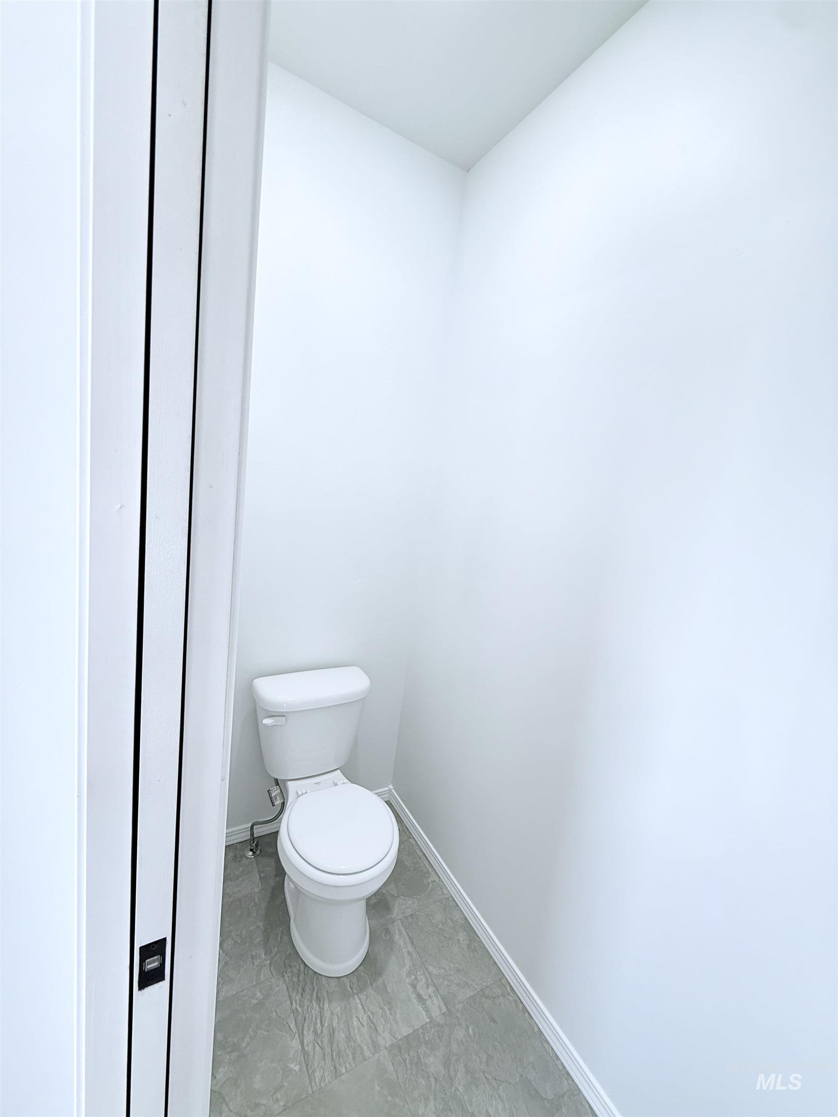 Bathroom with toilet and baseboards