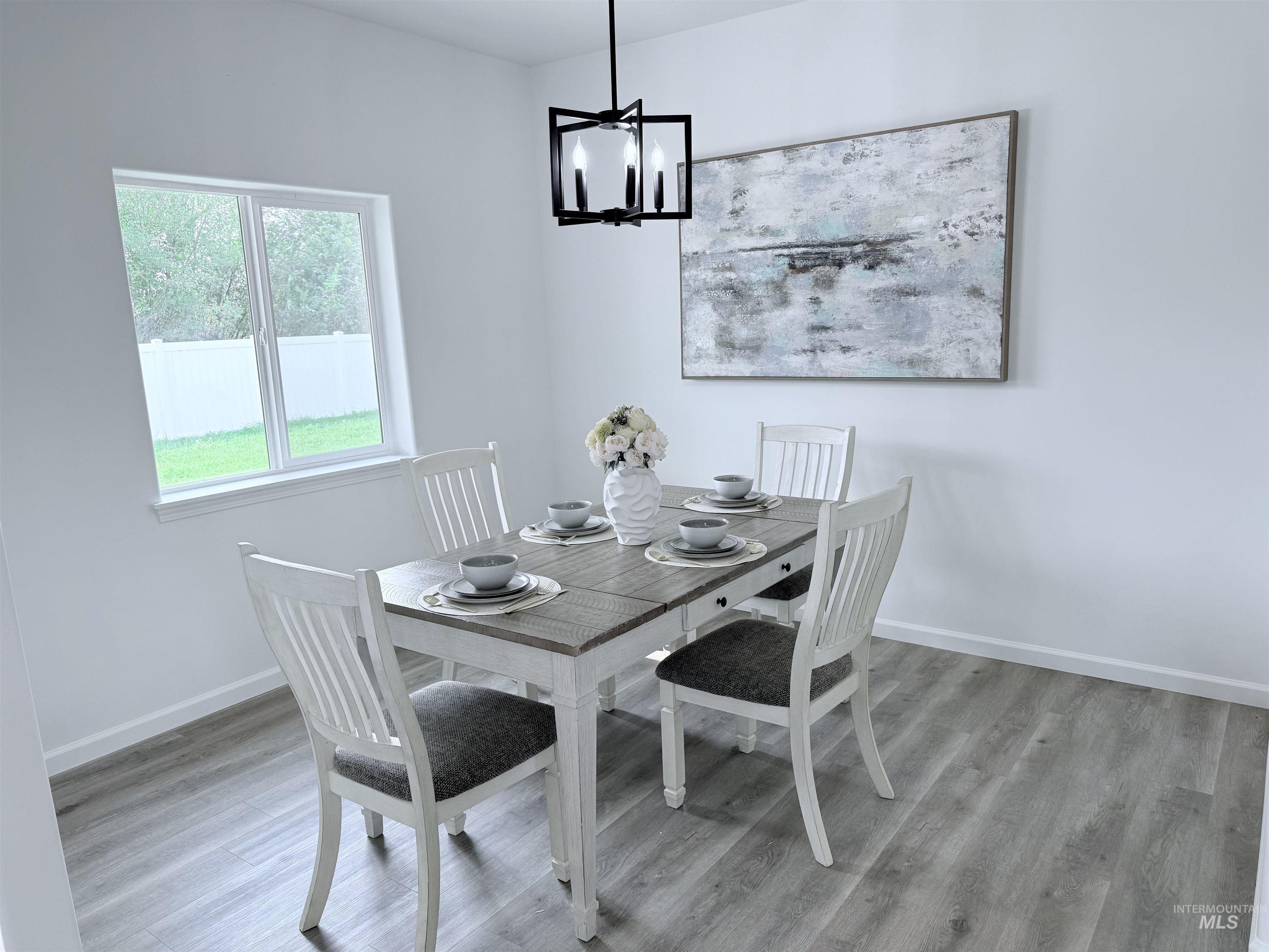 Dining room featuring light wood-style flooring and a chandelier