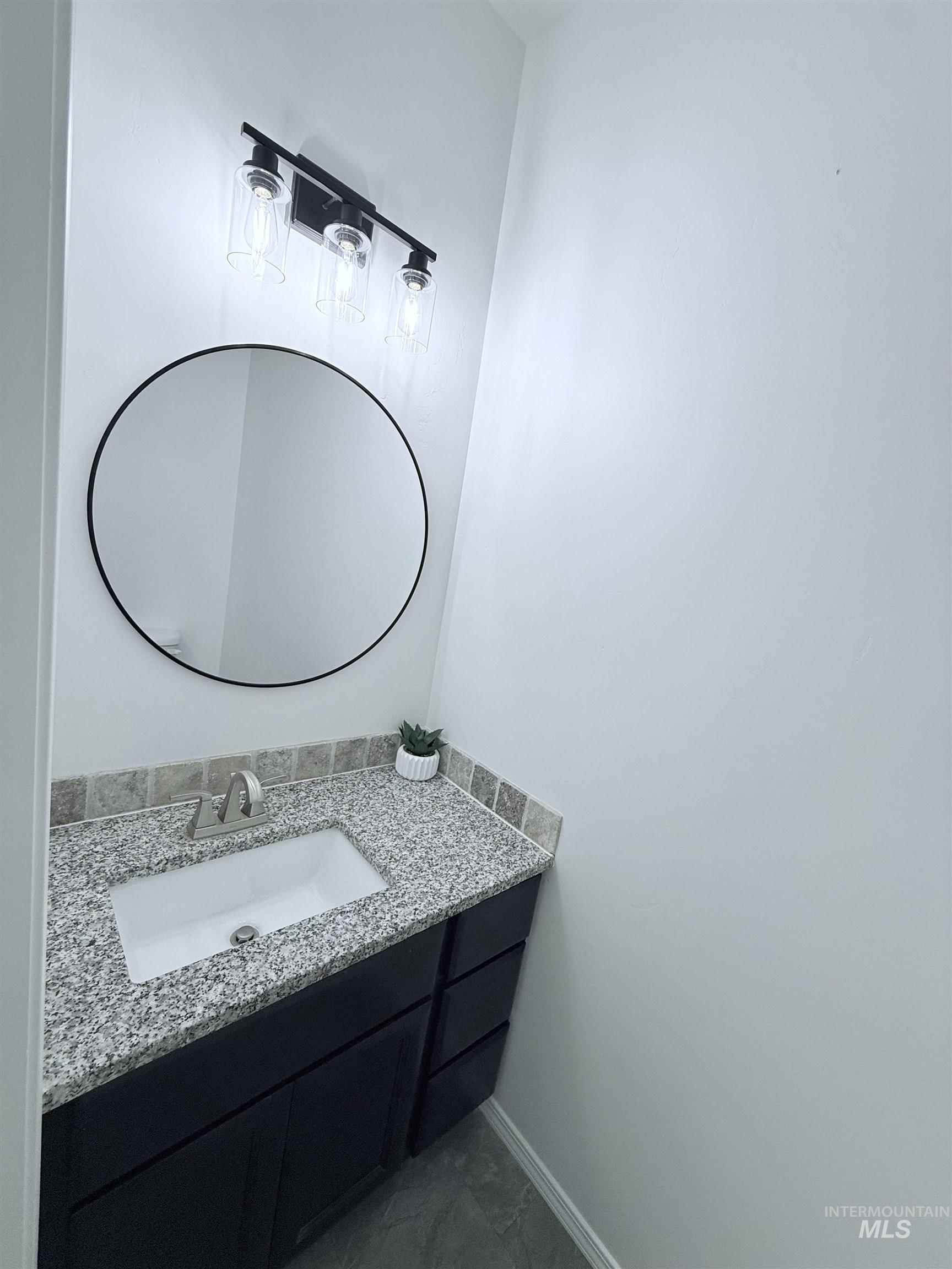 Bathroom with vanity and baseboards