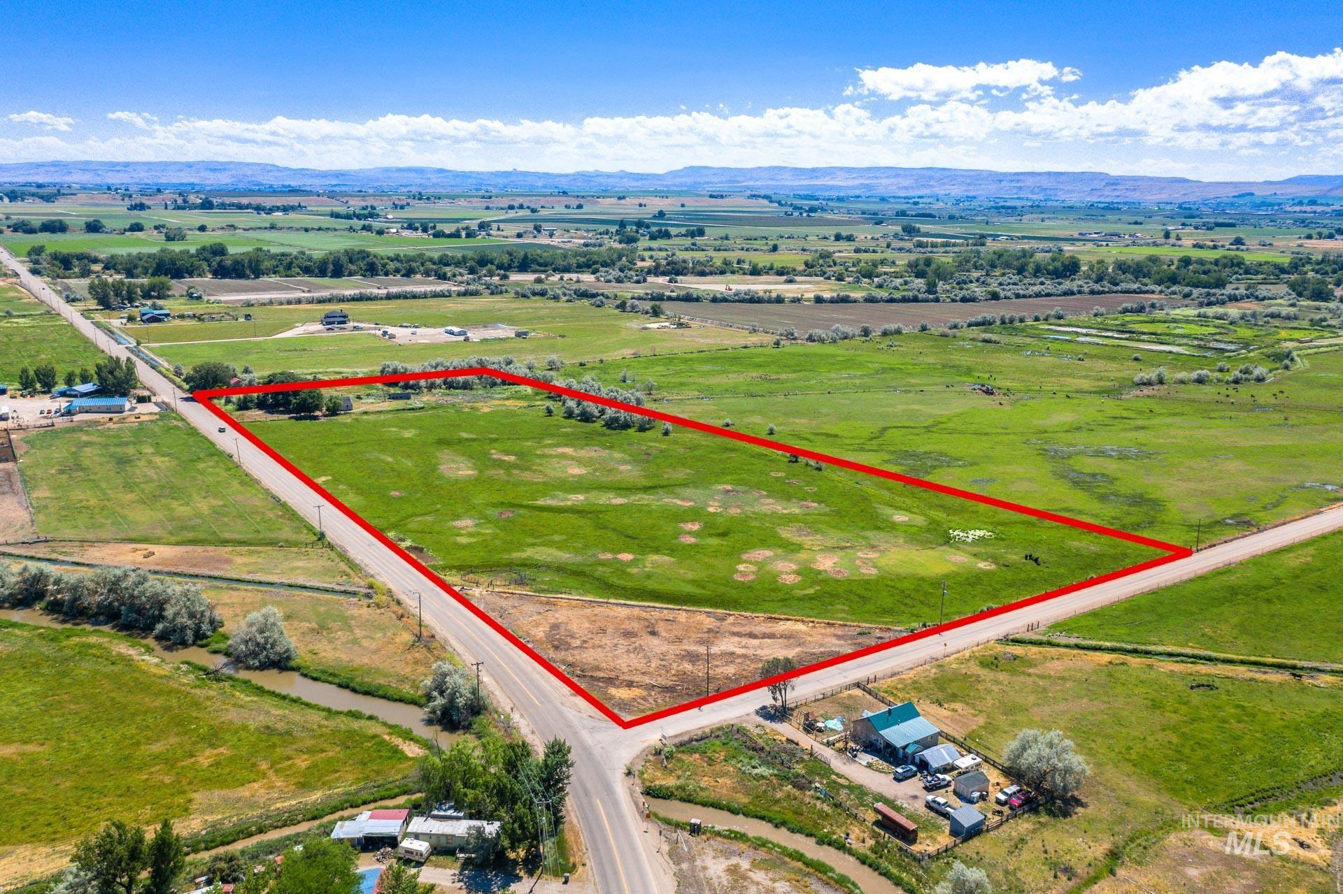 Overview of rural landscape with property boundaries highlighted and a mountainous background