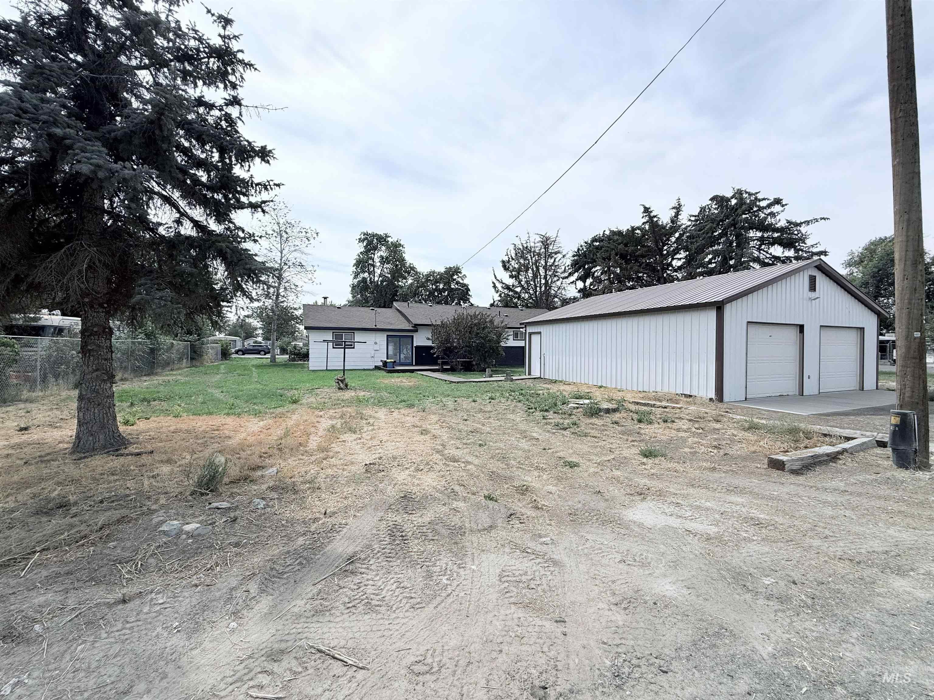 View of yard featuring an outdoor structure and a garage